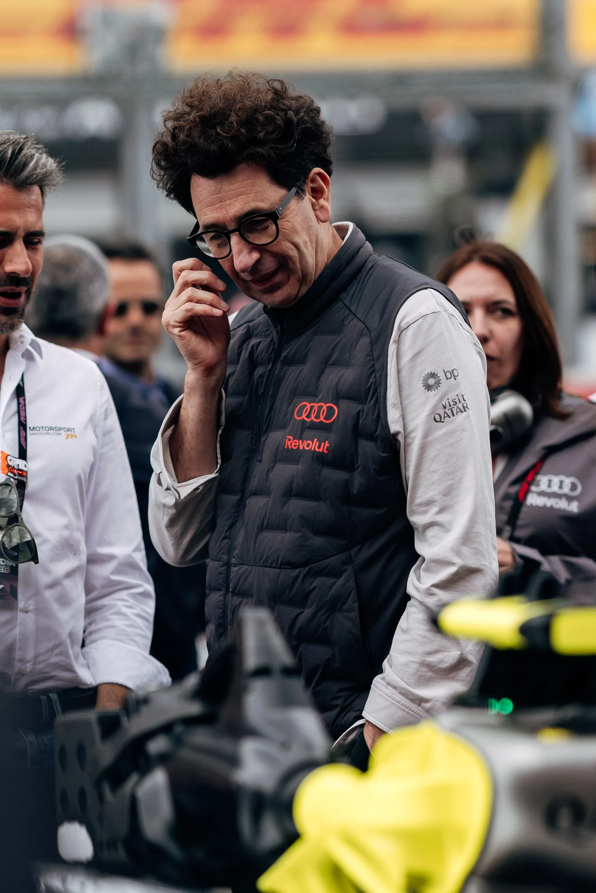 Mattia Binotto observes the car while speaking with Audi Revolut F1® Team personnel in the garage area at Spa-Francorchamps.