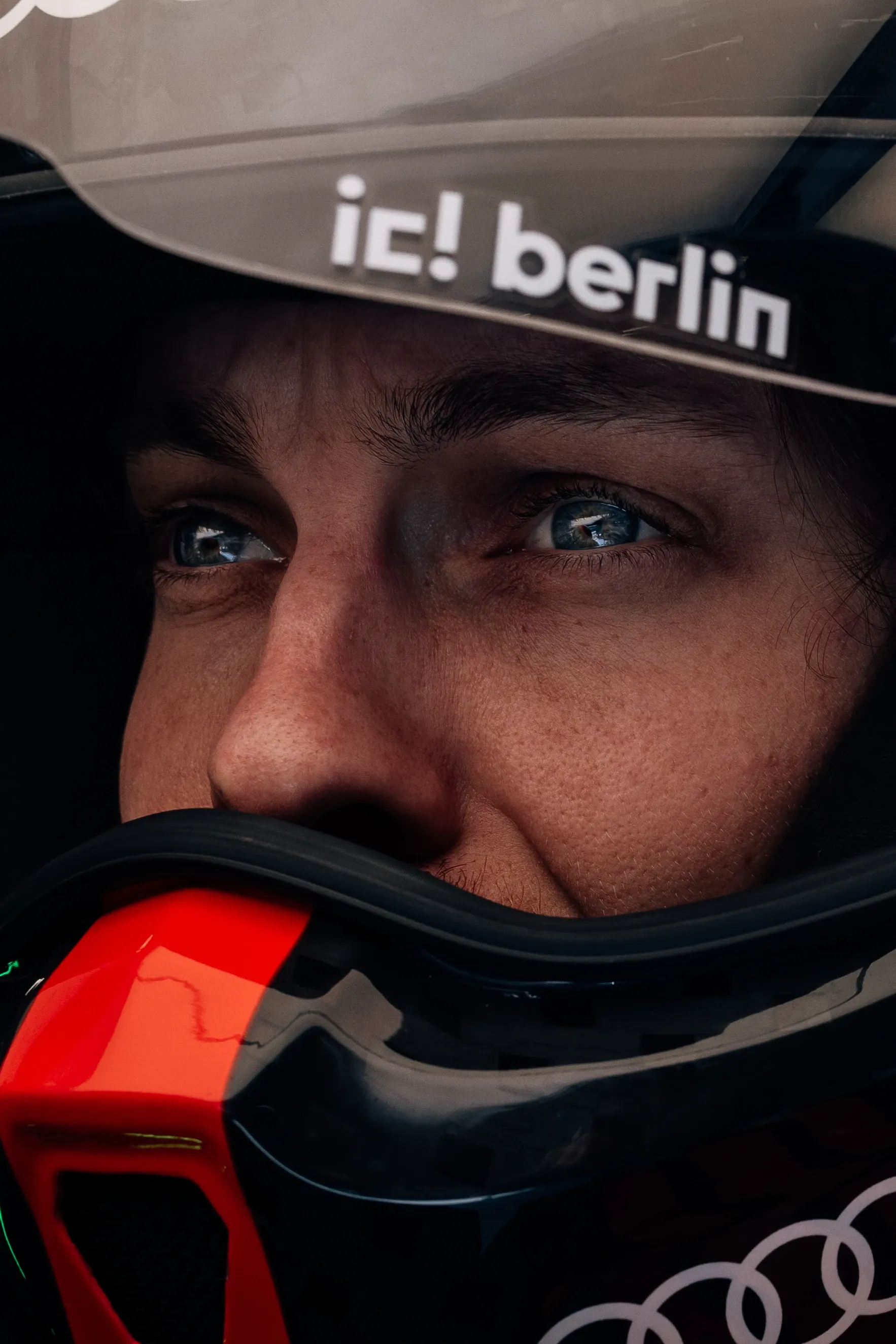 Close-up of an Audi Revolut F1® Team driver inside the cockpit of an Audi Revolut F1® Team R26, eyes focused ahead beneath the helmet visor