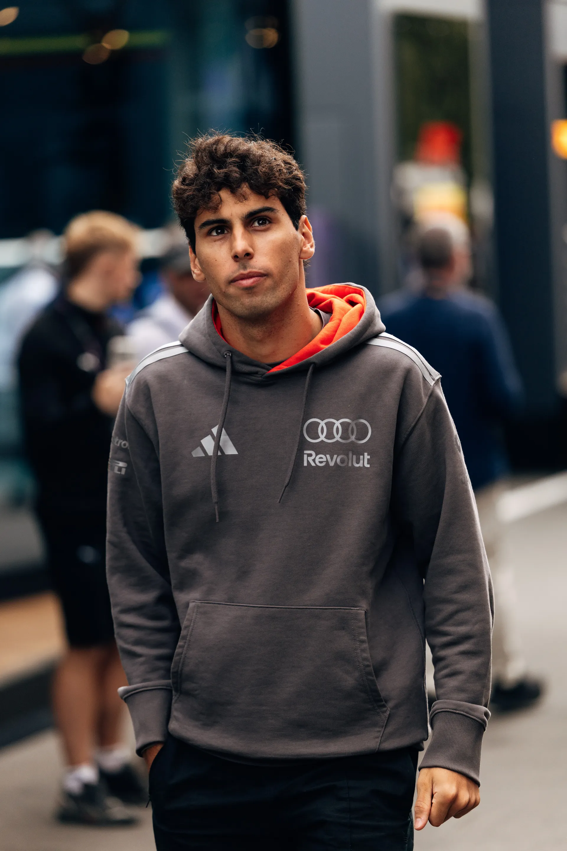 Gabriel Bortoleto of Audi Revolut F1® Team walks through the paddock at Spa Francorchamps on Sunday ahead of the Belgian Grand Prix
