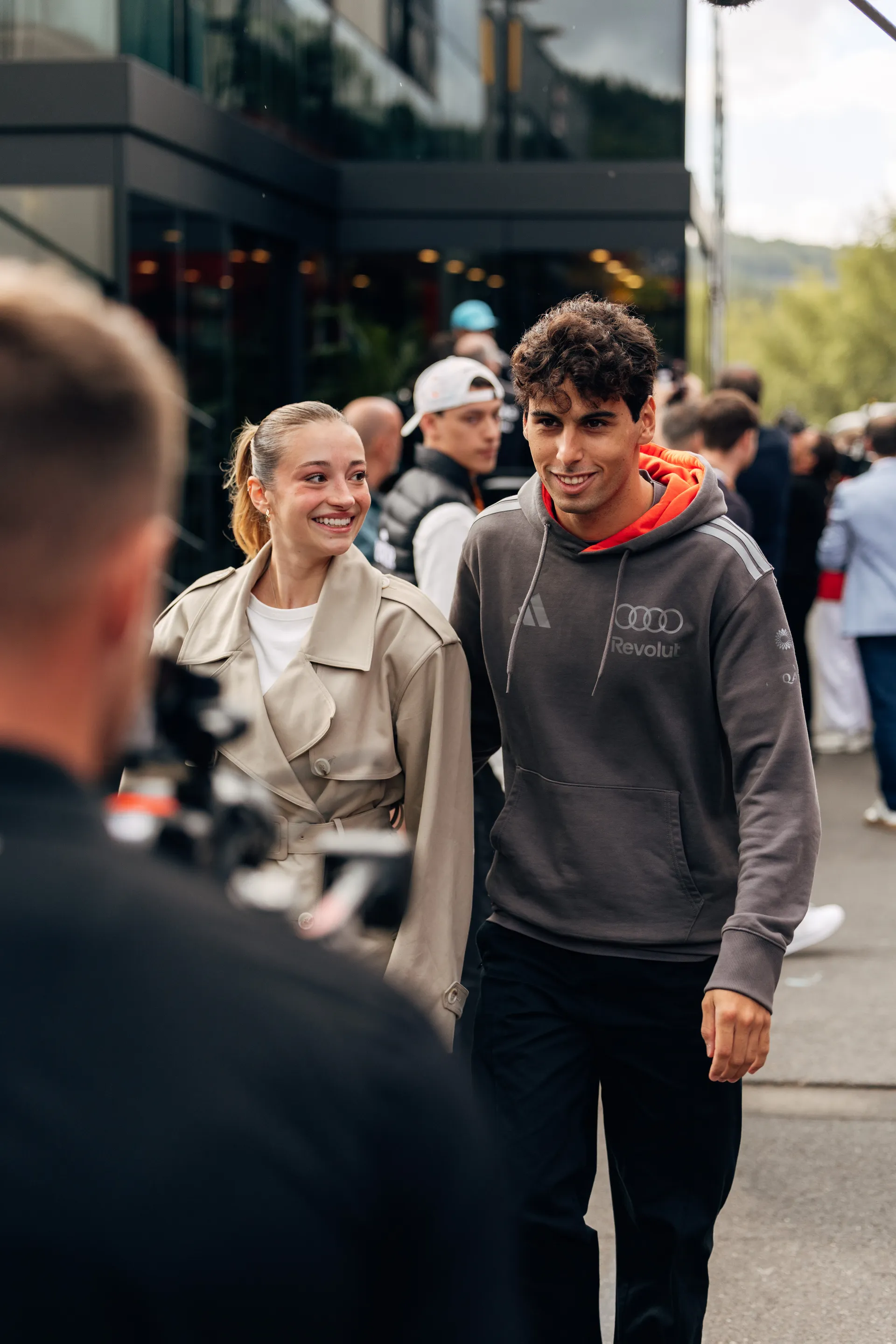 Gabriel Bortoleto of Audi Revolut F1® Team arrives in the paddock with a companion at Spa Francorchamps on Sunday before the Belgian Grand Prix