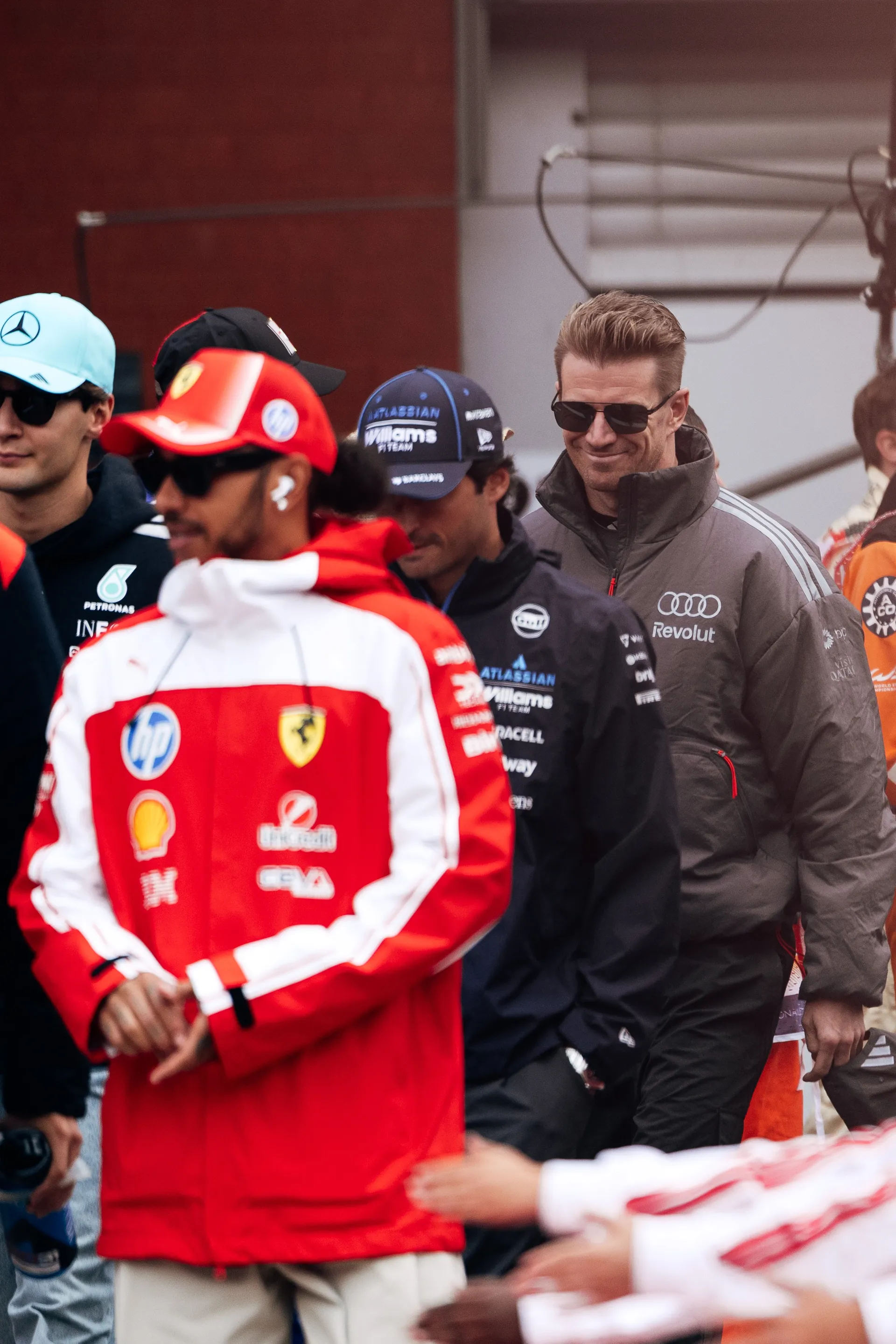 Nico Hulkenberg of Audi Revolut F1® Team walks in the drivers parade at Spa Francorchamps among other Formula 1 drivers, including Lewis Hamilton in Ferrari teamwear and George Russell in Mercedes teamwear