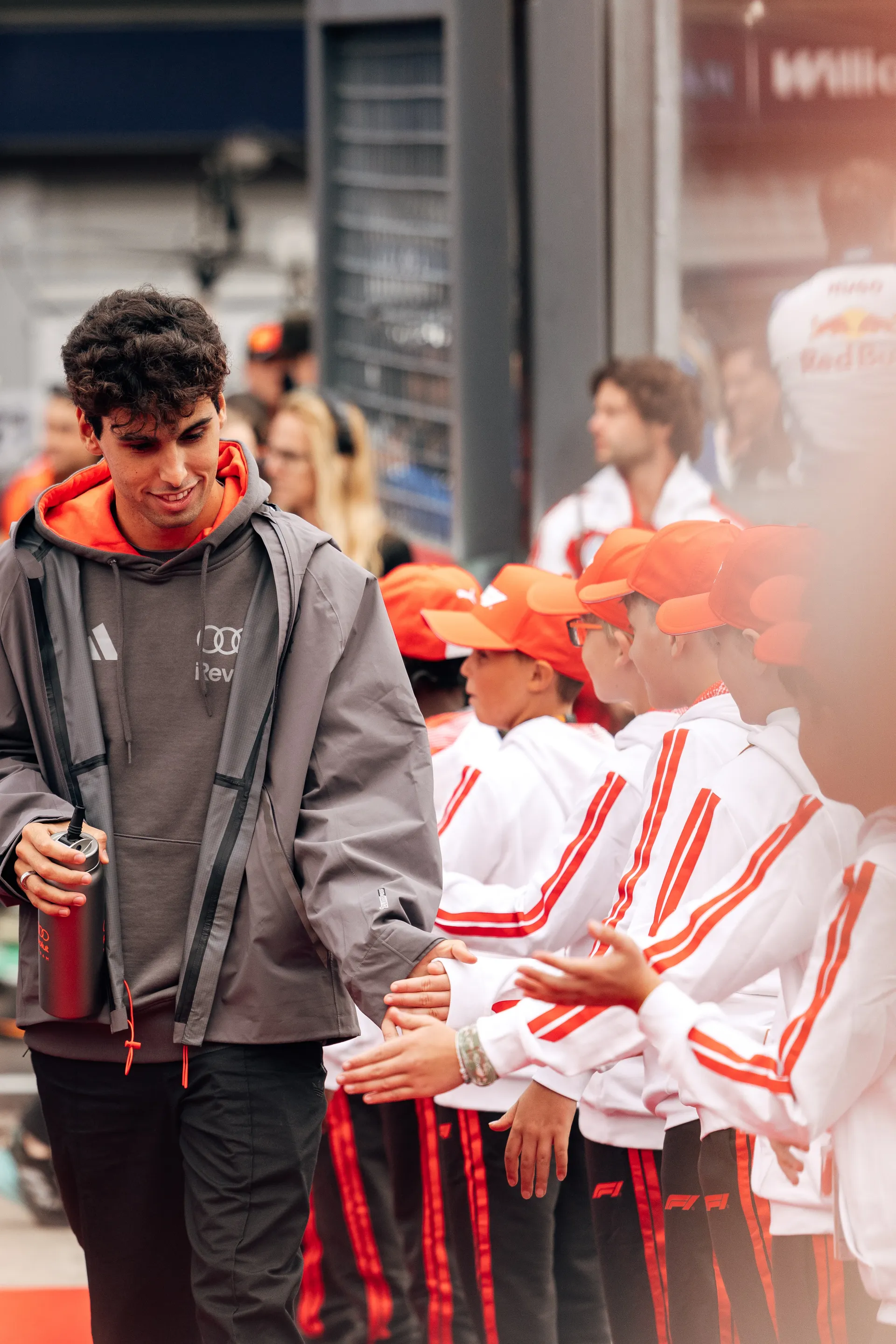 Gabriel Bortoleto of Audi Revolut F1® Team walks along the drivers parade greeting young fans lined up in team outfits at Spa Francorchamps