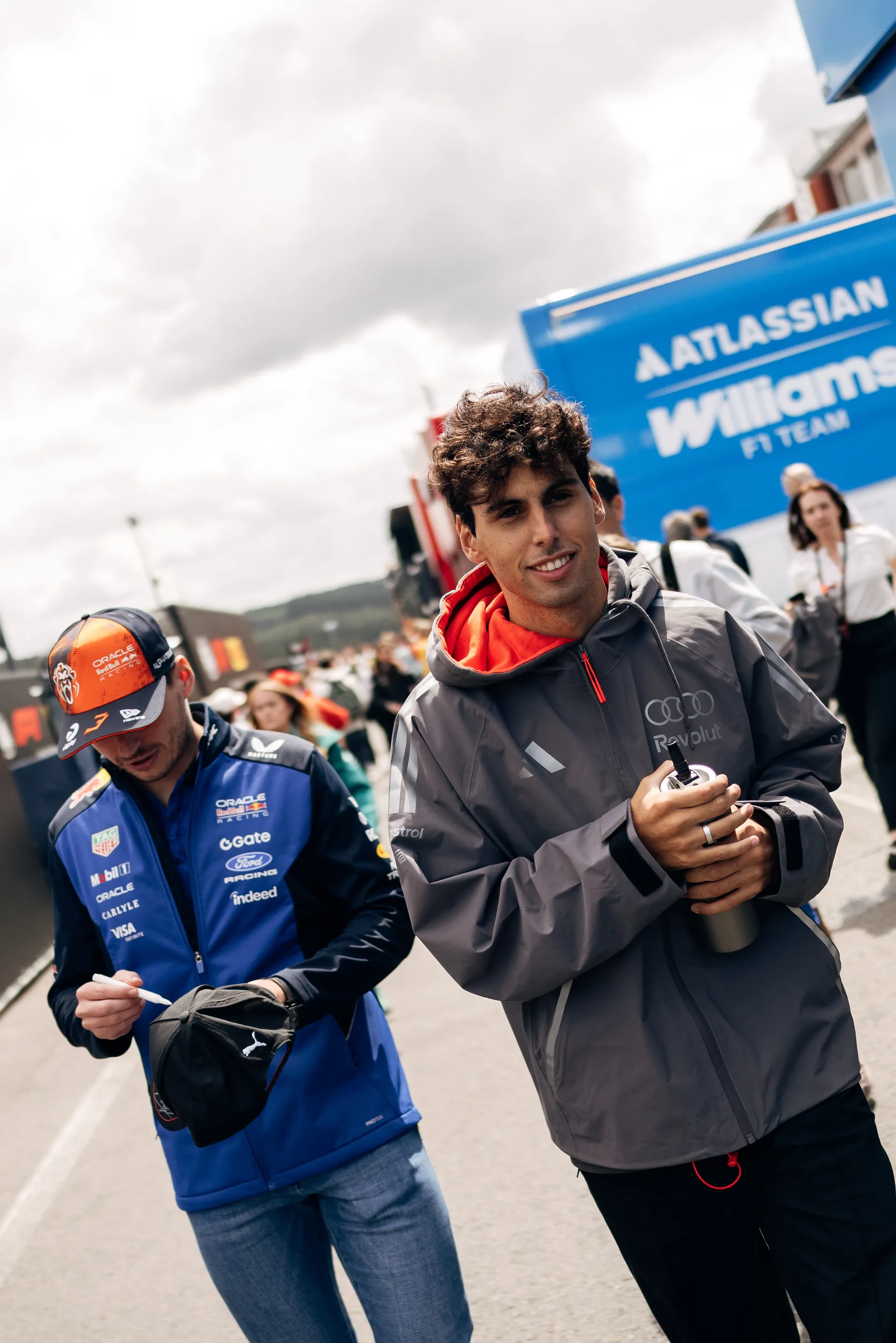 Gabriel Bortoleto of Audi Revolut F1® Team walks through the drivers parade area at Spa Francorchamps alongside Max Verstappen of Red Bull Racing on Belgian Grand Prix Sunday