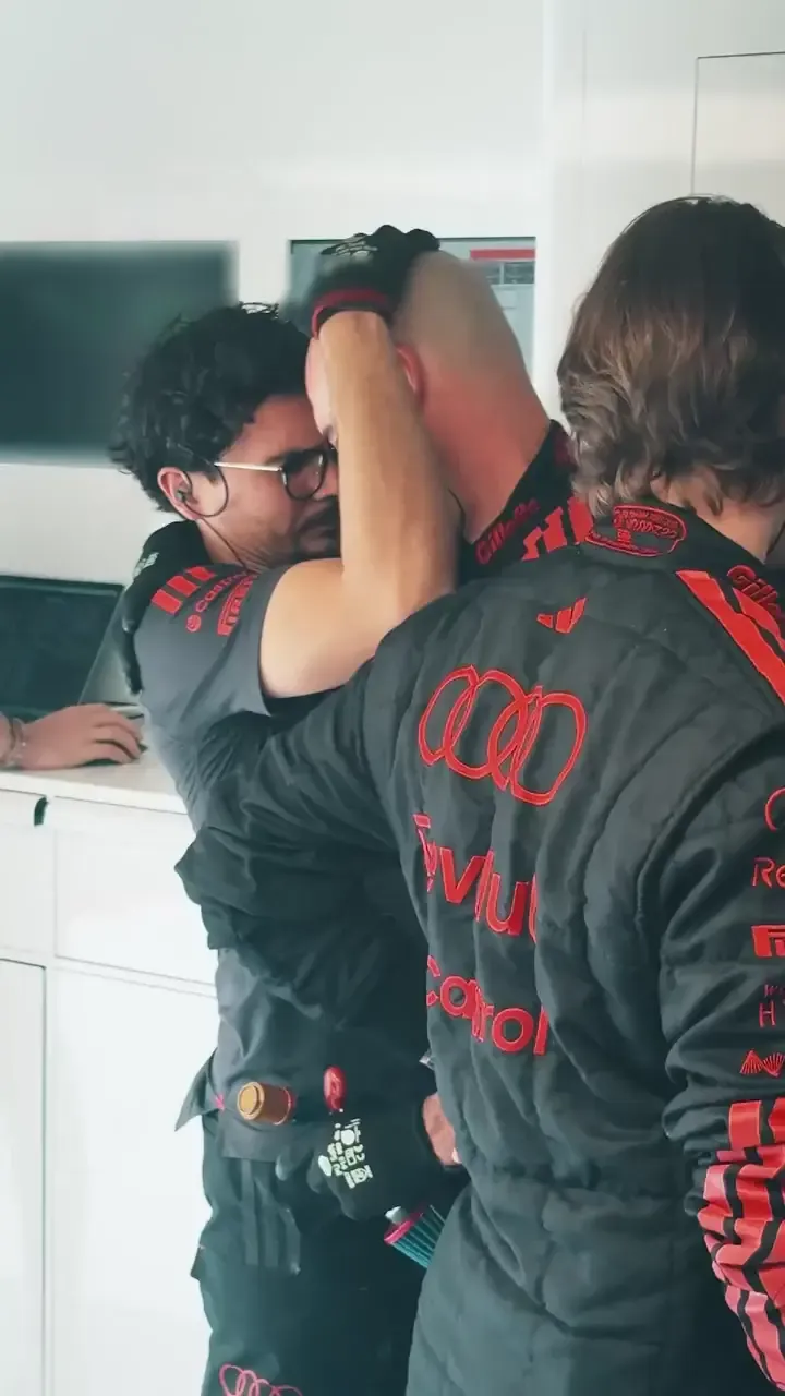Audi Revolut F1® Team mechanics celebrate in the garage after Gabriel Bortoleto completes a successful qualifying run at the Belgian Grand Prix.