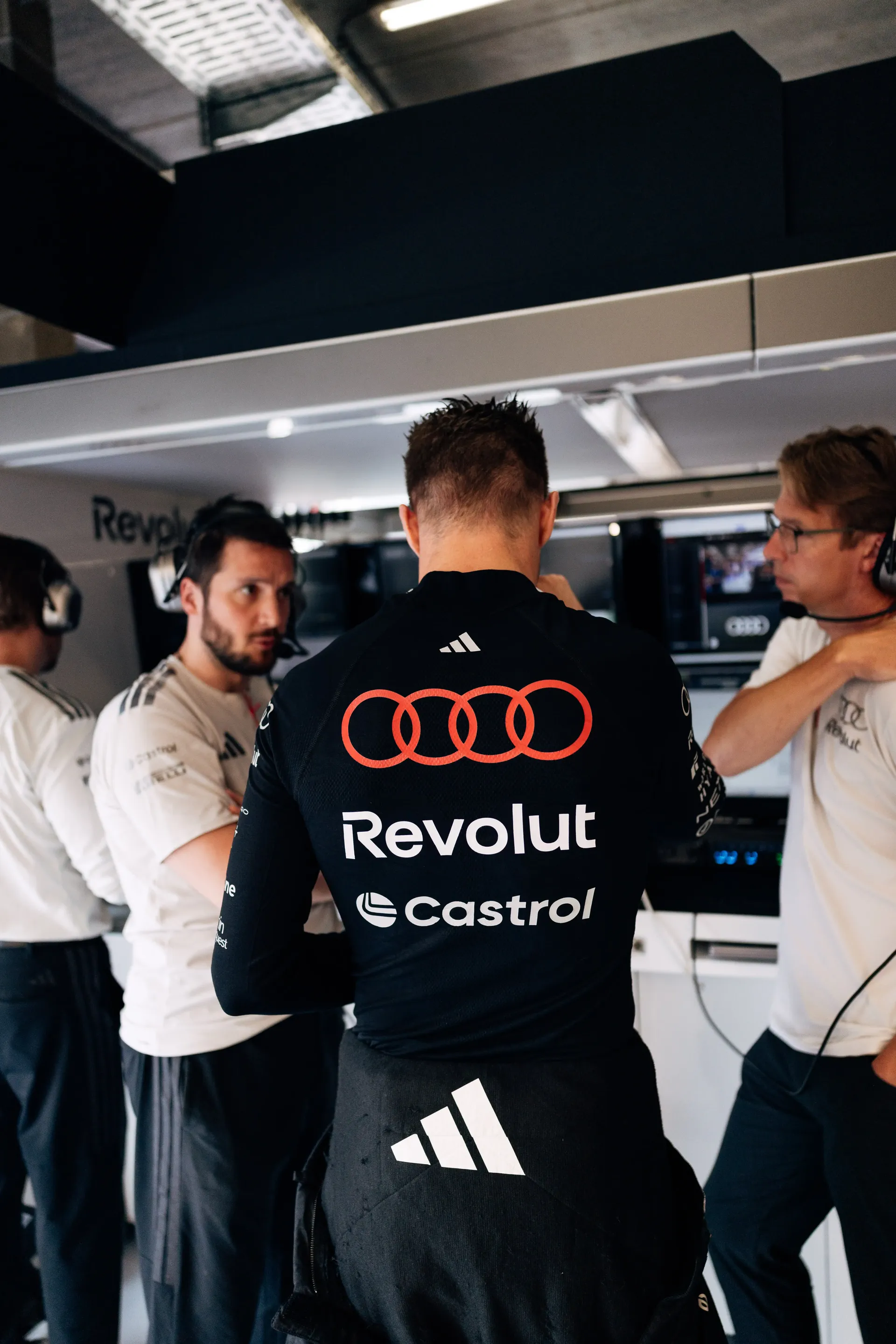 Audi Revolut F1® Team engineers and mechanics discuss preparations inside the garage before FP1 at the Formula 1® Belgian Grand Prix in Spa-Francorchamps.