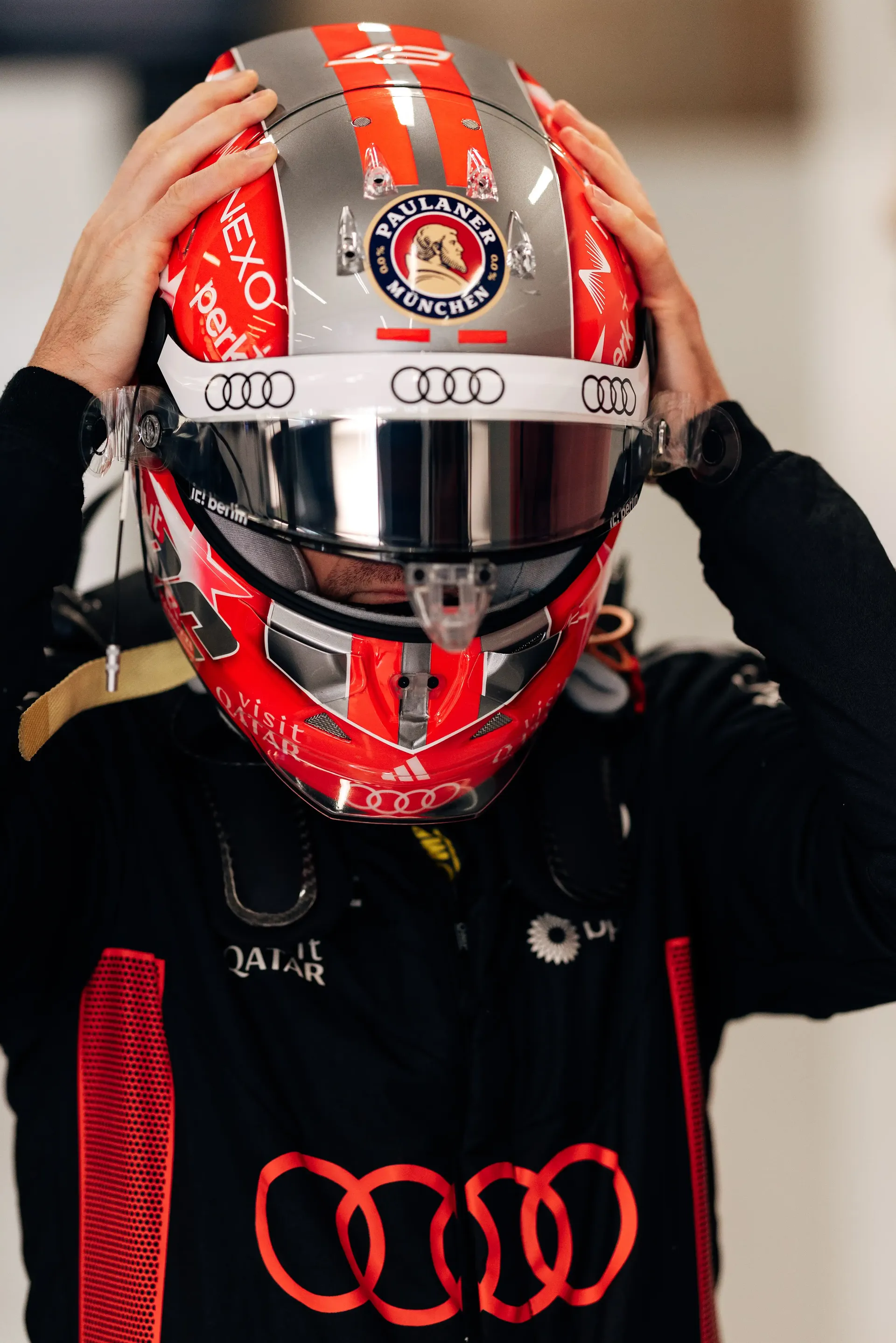 Nico Hulkenberg adjusts his special Belgian Grand Prix helmet inside the Audi Revolut F1® Team garage before FP1.