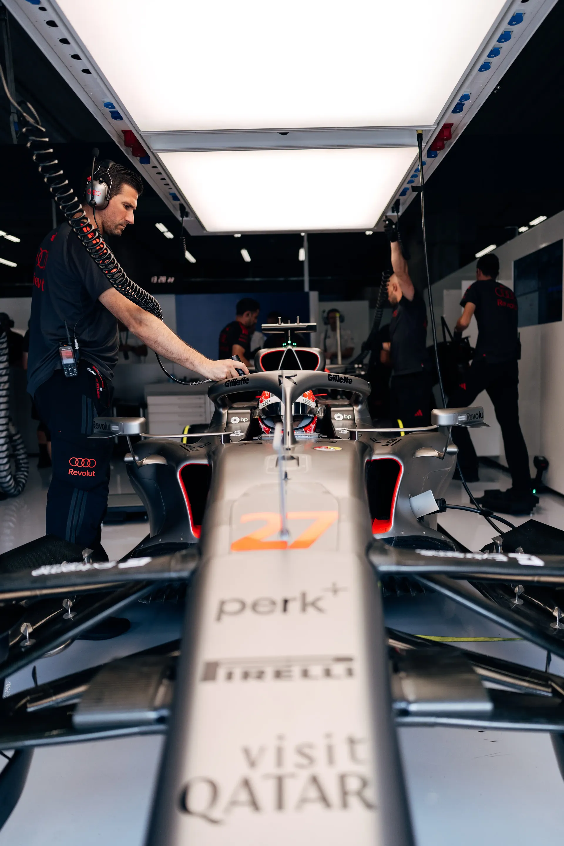 Audi Revolut F1® Team mechanics prepare the Formula 1® car inside the garage ahead of FP1 at Spa-Francorchamps.