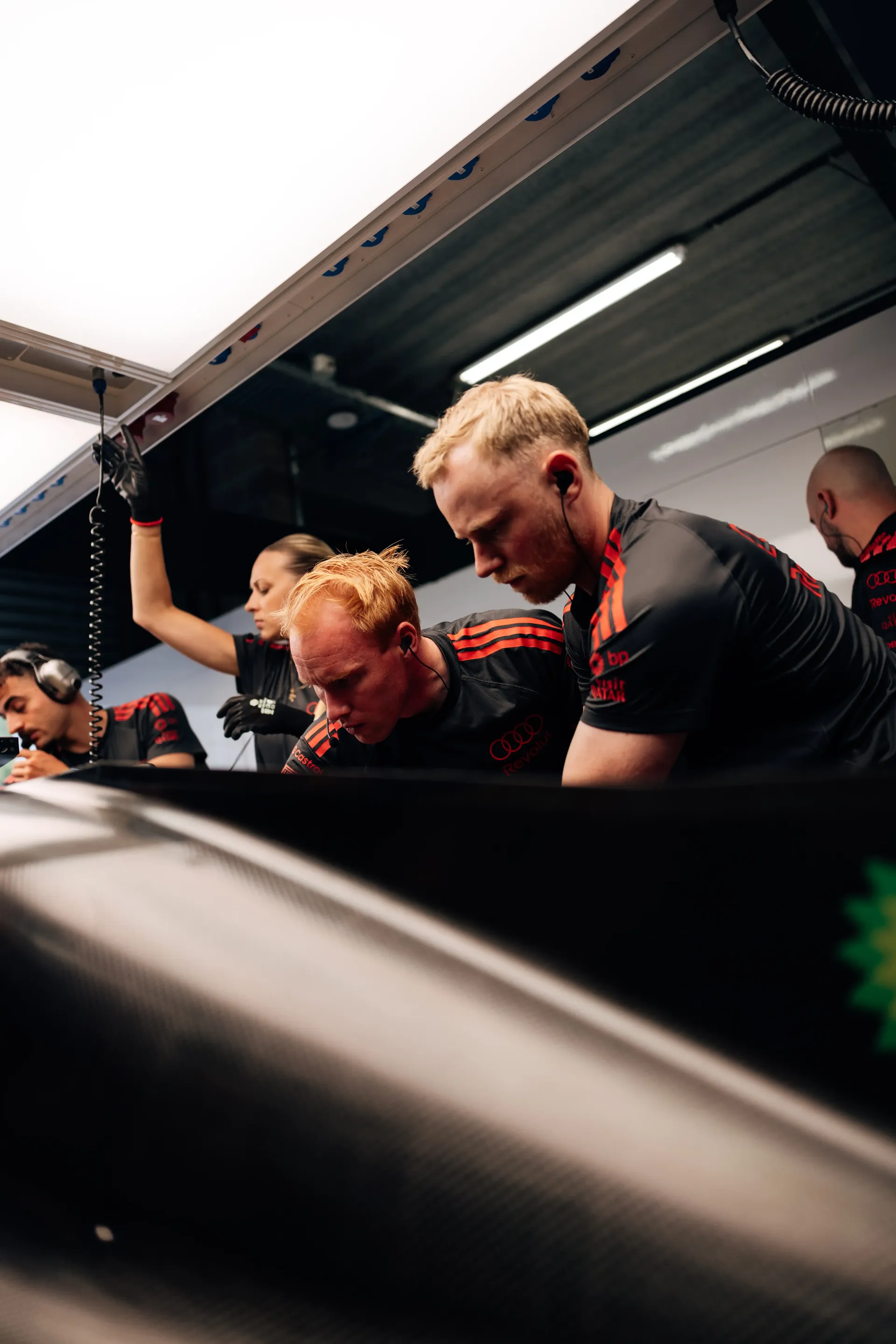 Audi Revolut F1® Team mechanics work on the car inside the garage during FP2 at the 2026 Belgian Grand Prix in Spa-Francorchamps.
