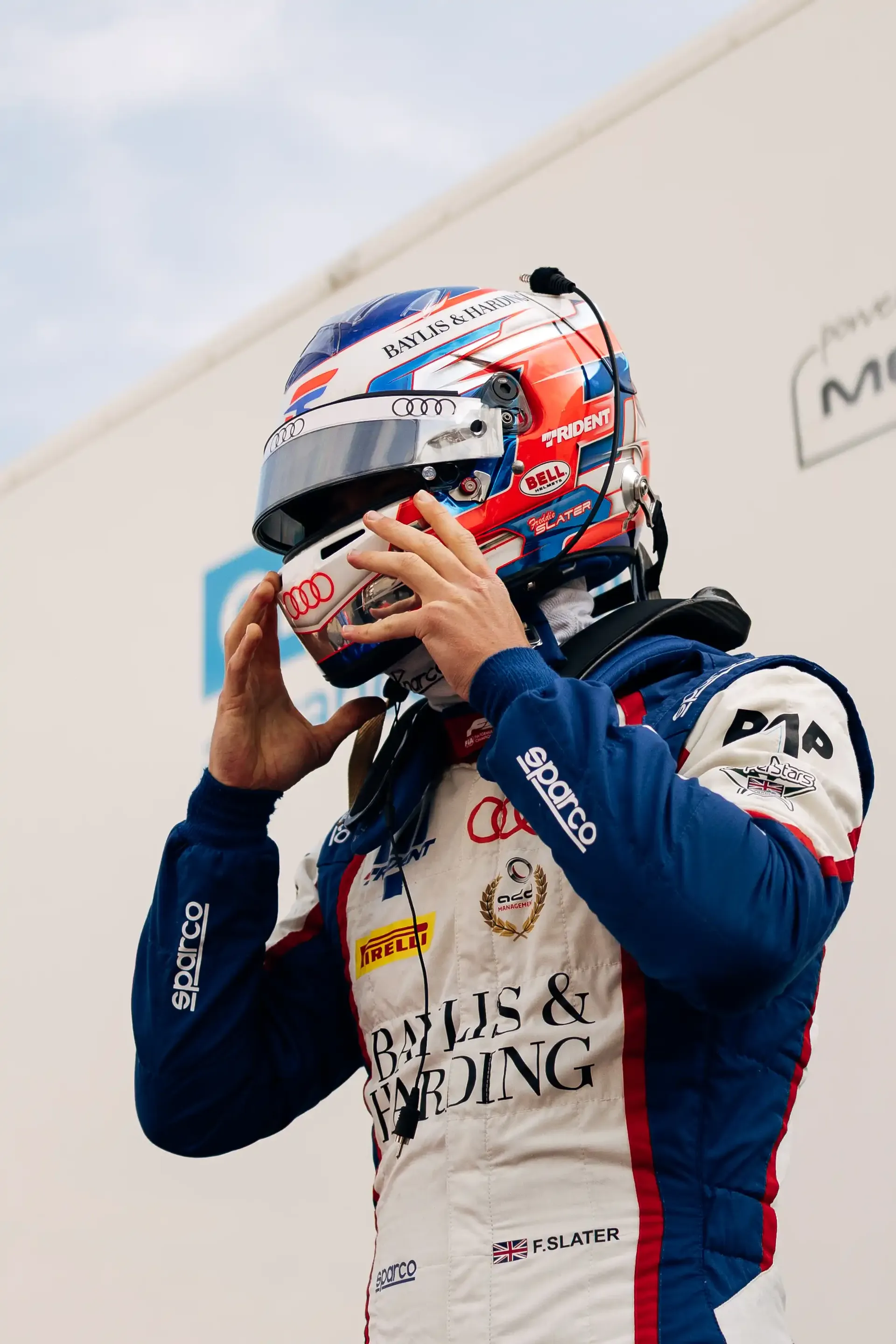 Freddie Slater fastens his helmet before heading out on track during the Formula 1® Belgian Grand Prix weekend with the Audi Revolut F1® Team.