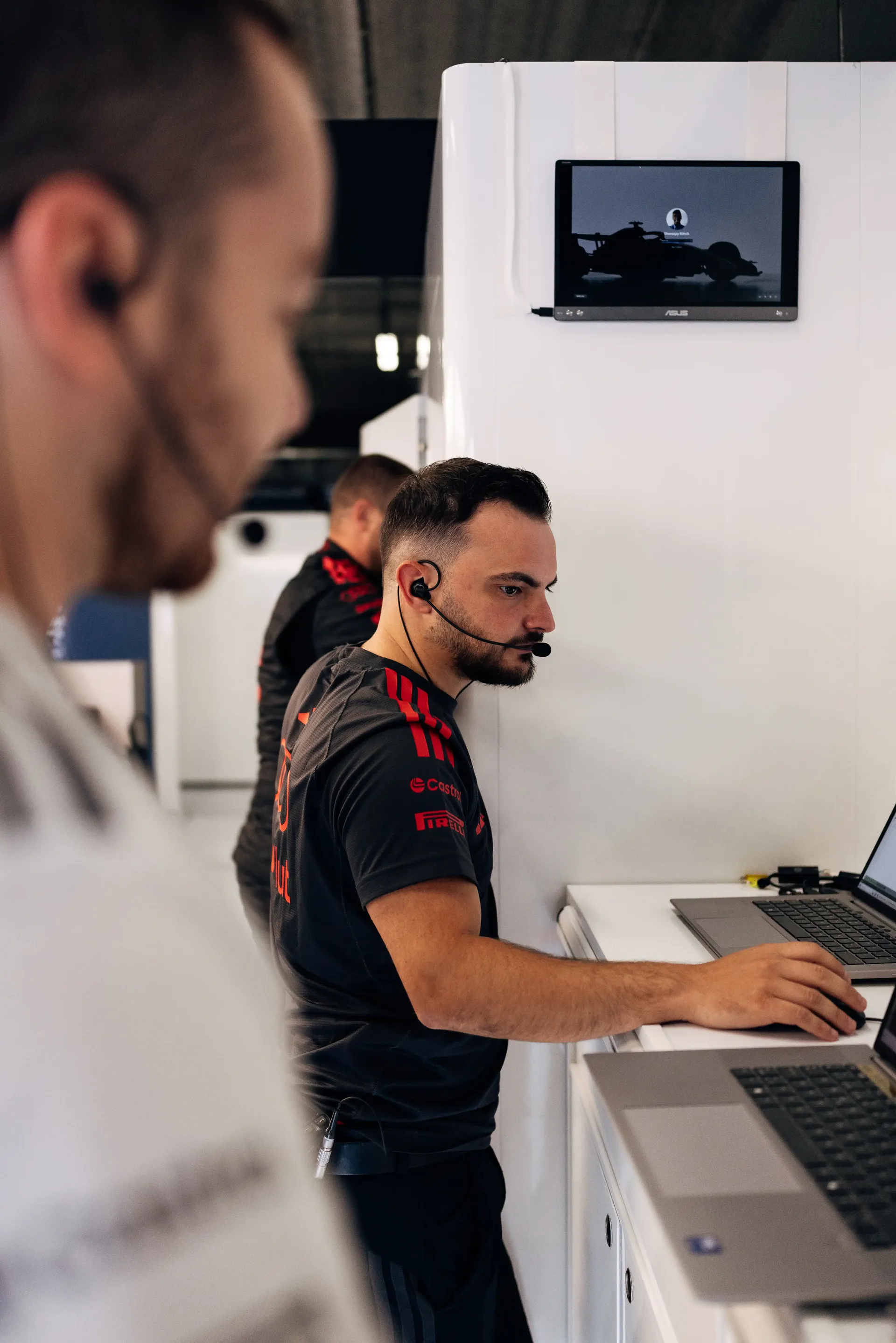 Audi Revolut F1® Team engineer monitors performance data inside the Audi Revolut F1® Team garage during Friday preparations.