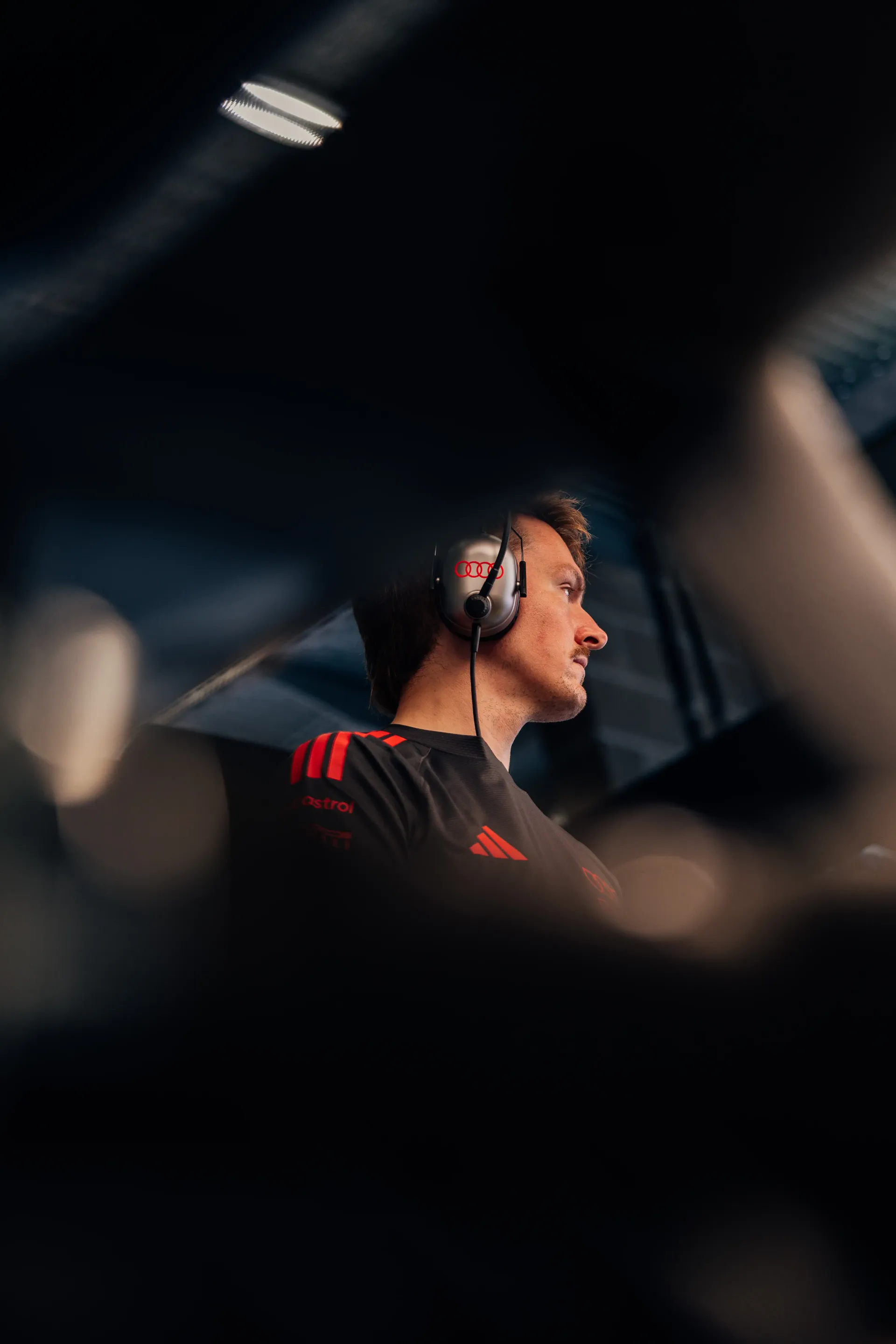 Audi Revolut F1® Team mechanic observes activity from inside the Formula 1® garage during Friday preparations.