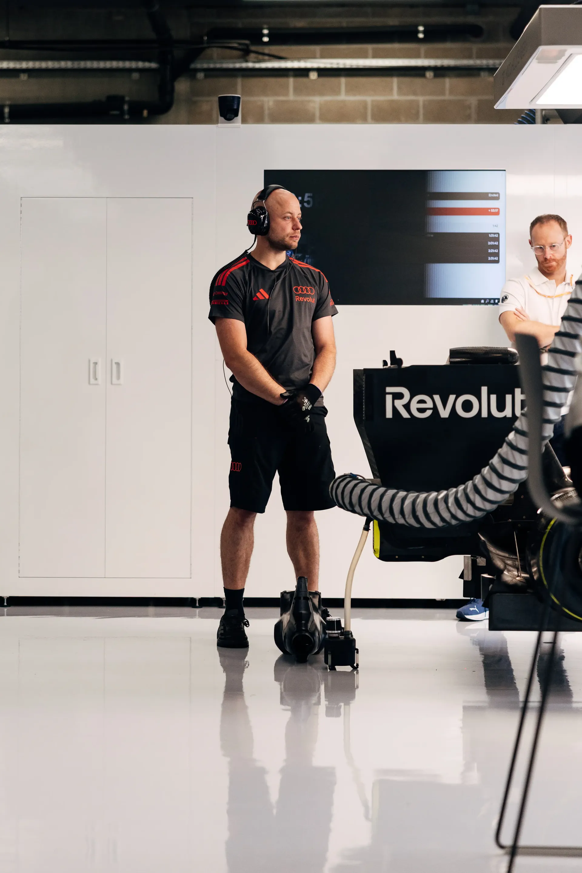 Audi Revolut F1® Team mechanic stands inside the Formula 1® garage during preparations for the Belgian Grand Prix.