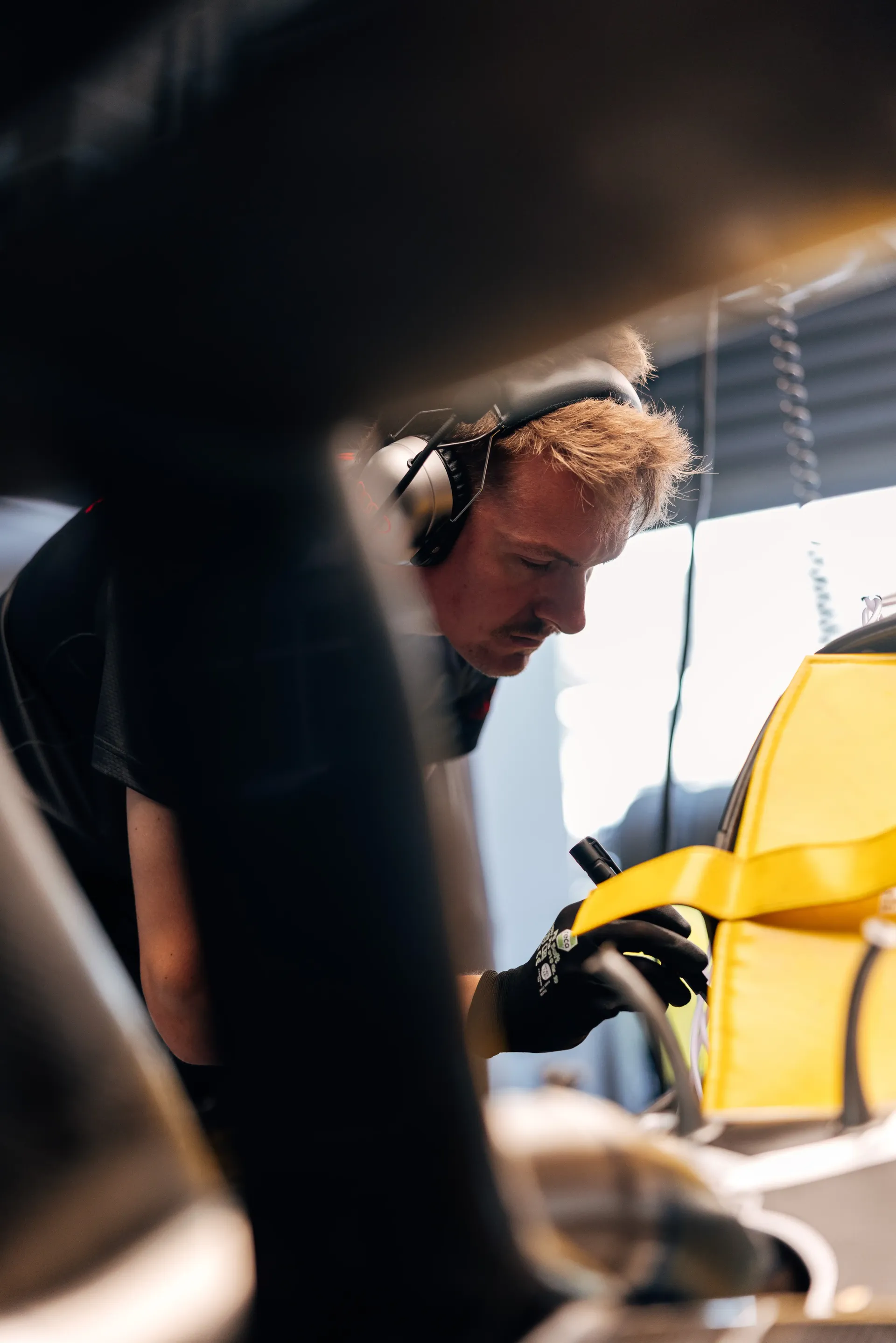 Audi Revolut F1® Team mechanic works on the Formula 1® car inside the Audi Revolut F1® Team garage before Friday running at Spa-Francorchamps.