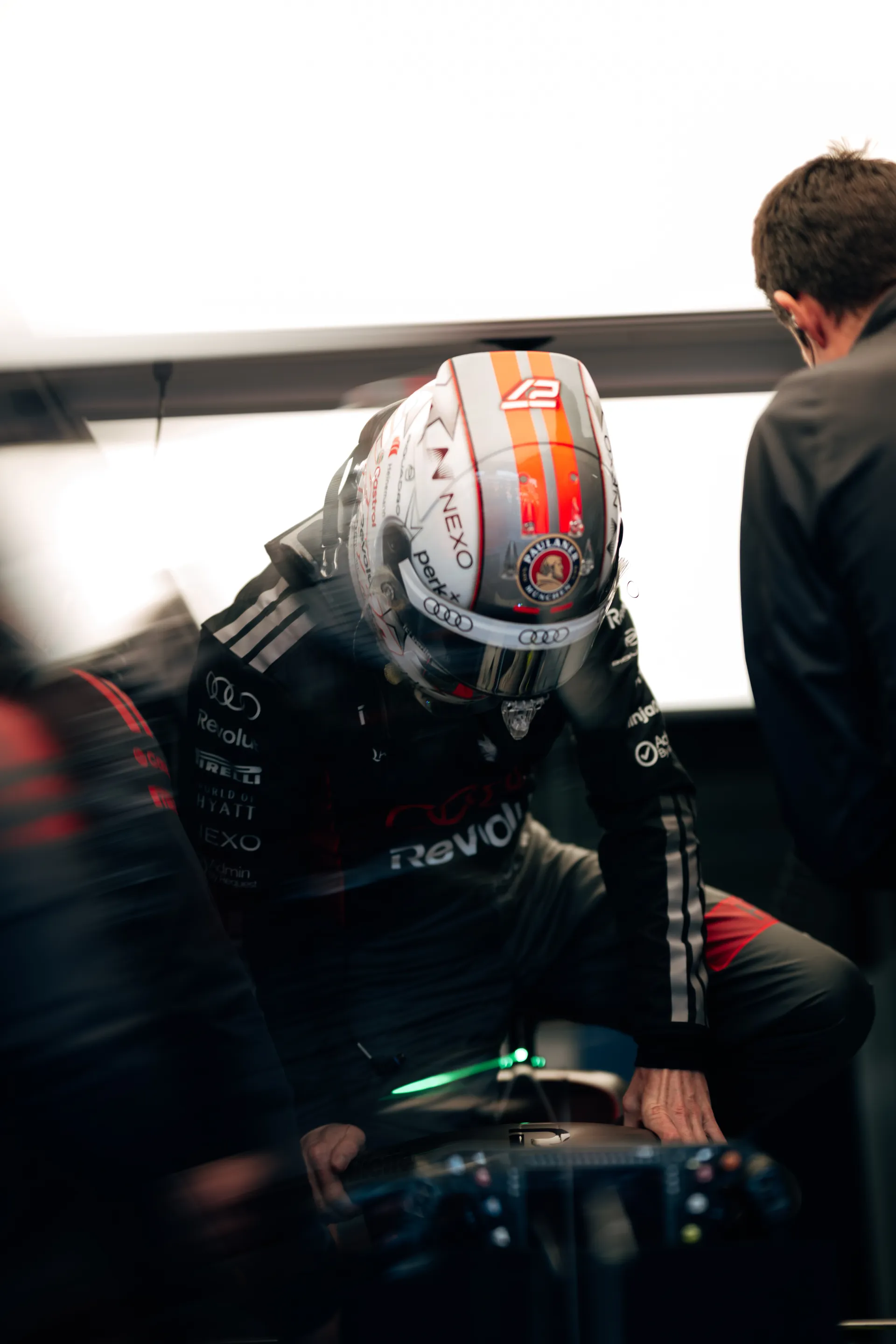 Gabriel Bortoleto driver at the Audi Revolut F1® Team jumps into the cockpit of the Audi R26 inside the garage