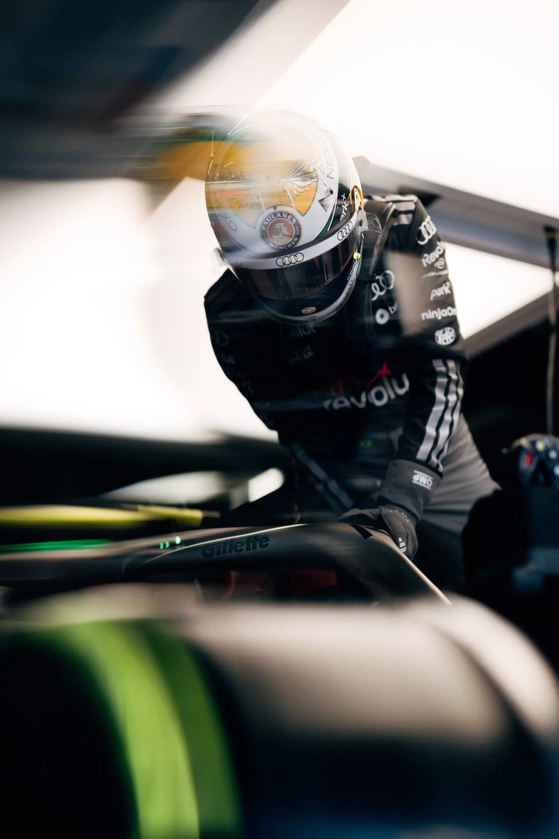 Gabriel Bortoleto driver at the Audi Revolut F1® Team jumps into the cockpit of the Audi R26 inside the garage