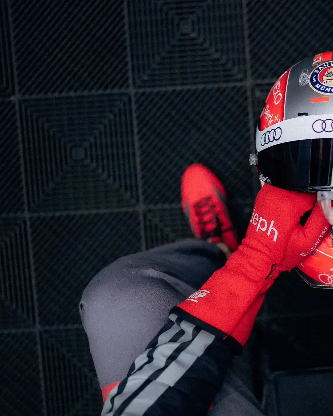 Top-down view of Nico Hulkenberg wearing his special Belgian Grand Prix helmet while seated in the Audi Revolut F1® Team garage.