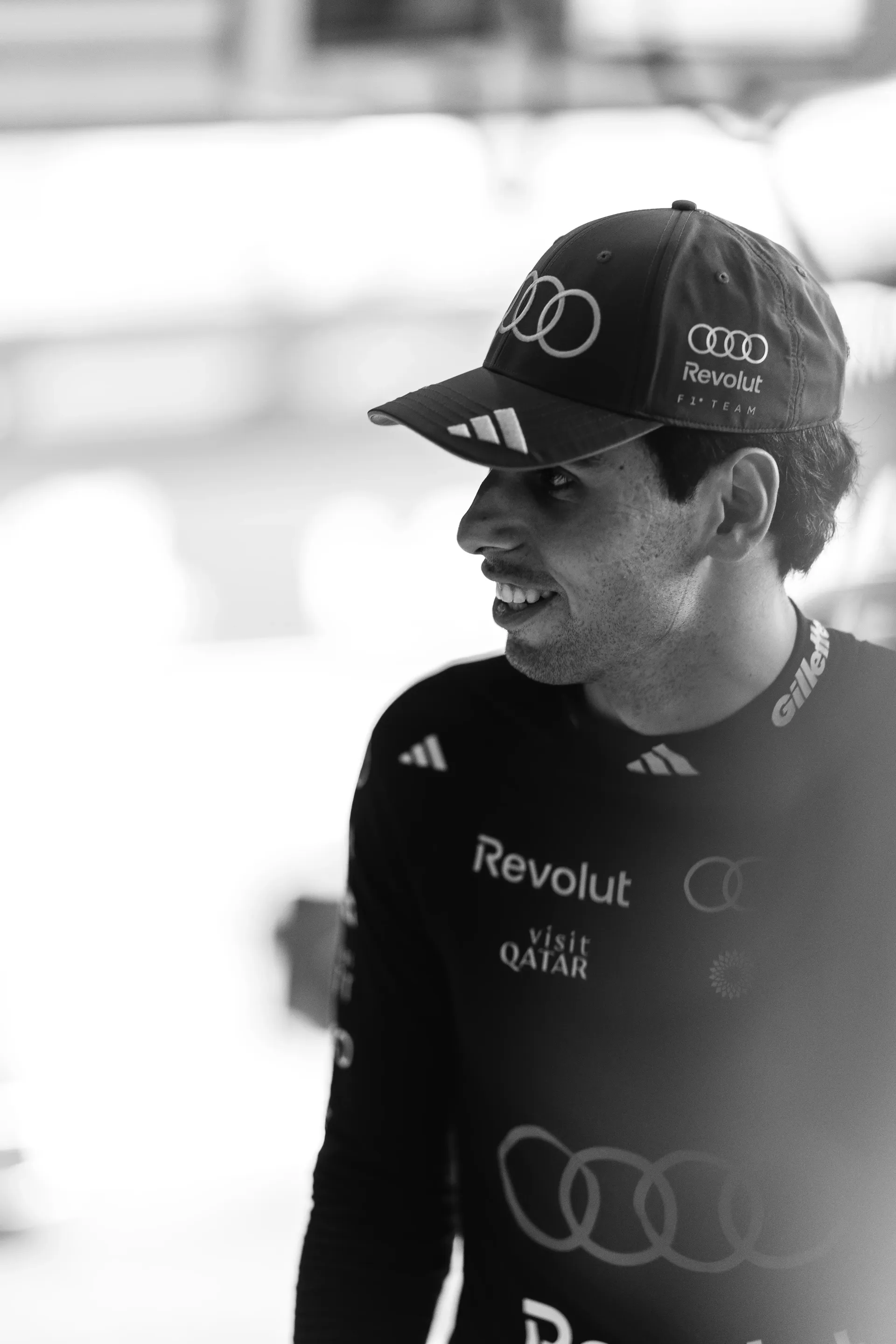 Black and white close up of Gabriel Bortoleto driver at Audi Revolut F1® Team inside the garage at Belgian Grand Prix 2026