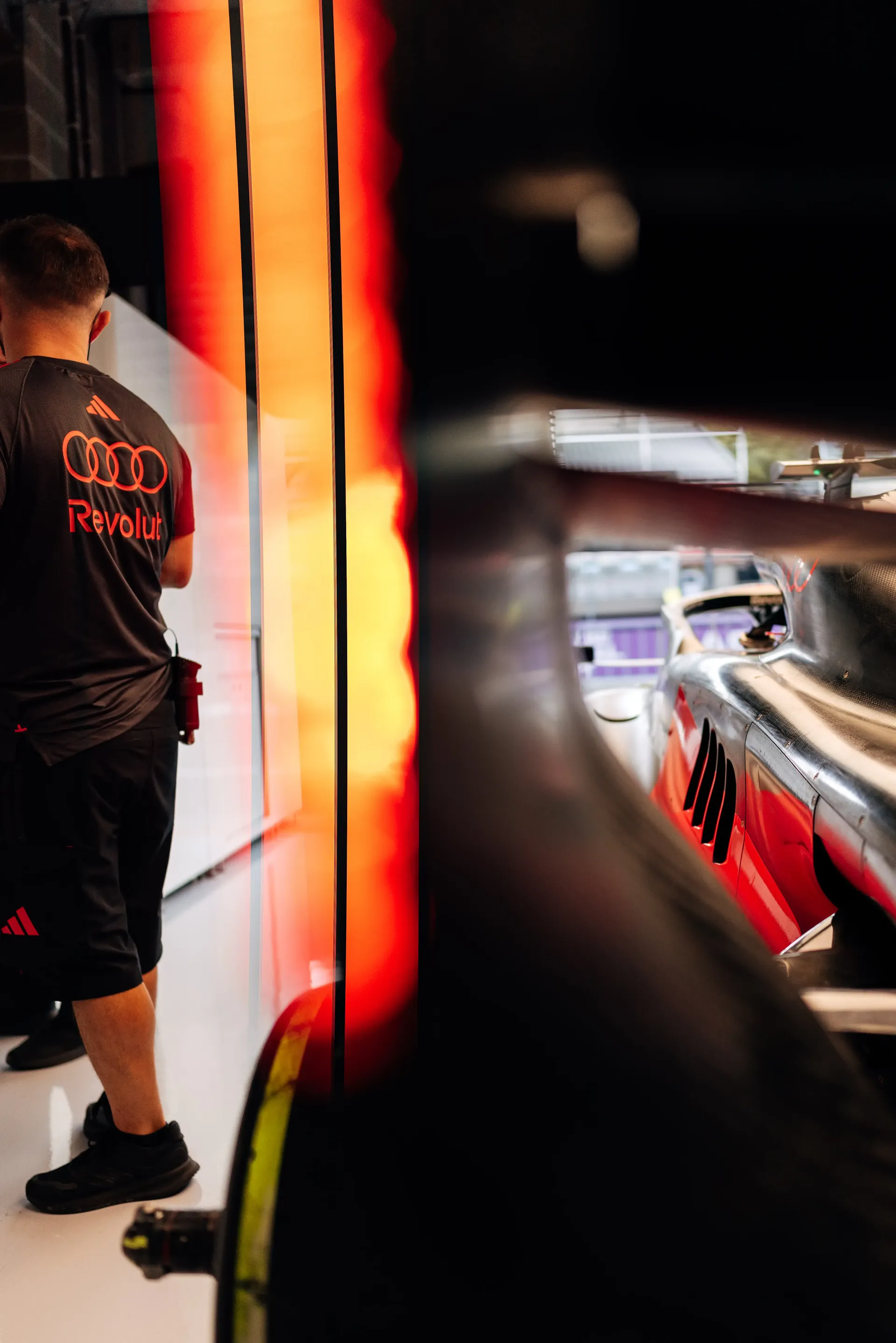 Audi Revolut F1® Team garage detail during Thursday preparations ahead of the Belgian Grand Prix, with the race car partially visible through the garage structure.