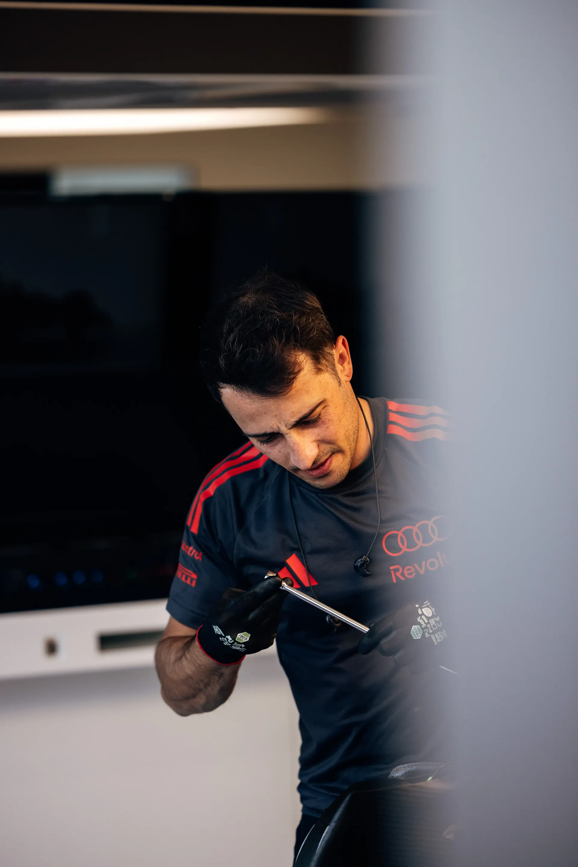 Audi Revolut F1® Team mechanic working inside the garage during Thursday setup ahead of the Belgian Grand Prix at Spa-Francorchamps.