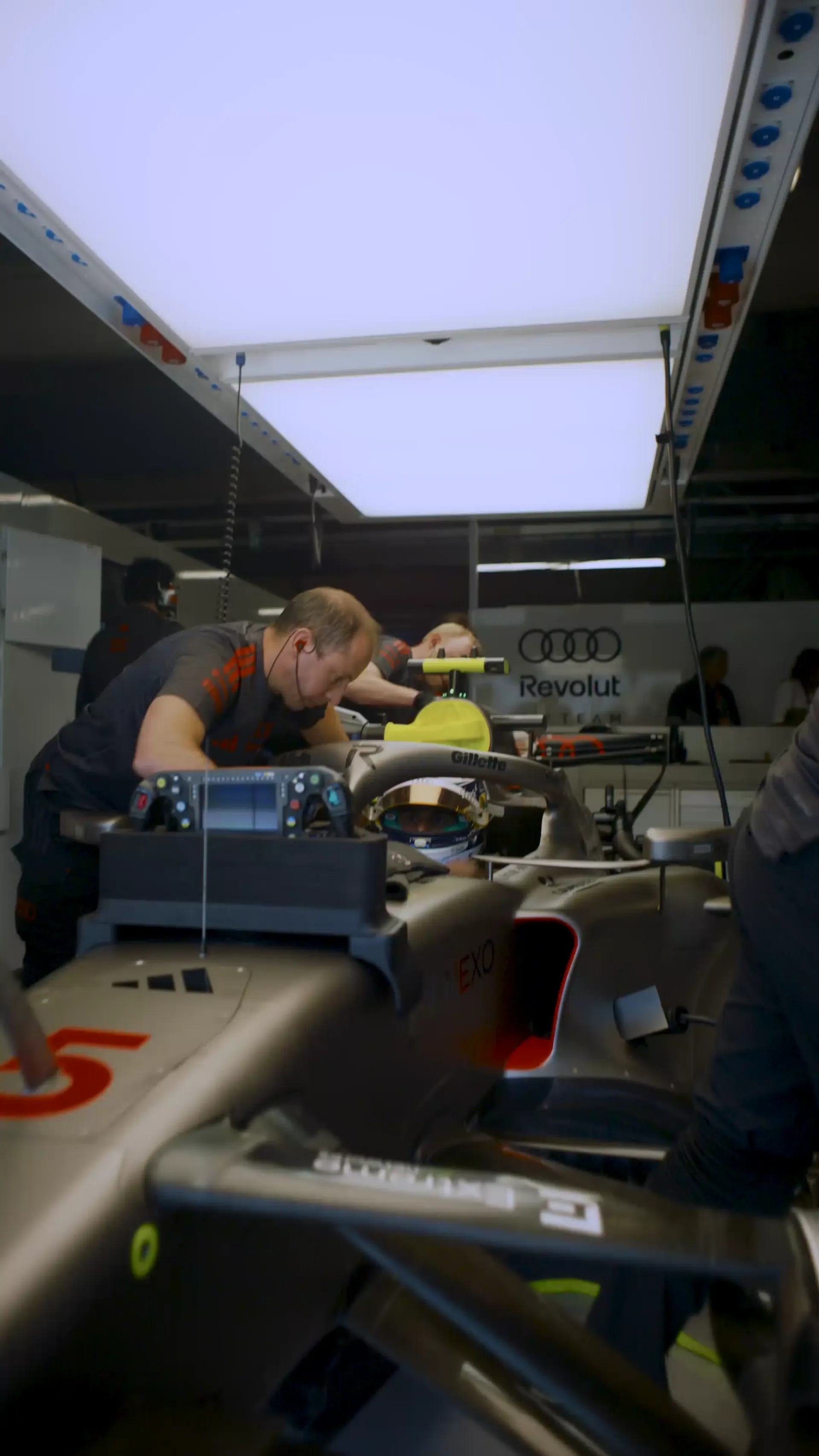 Gabriel Bortoleto jumnping out of the cockpit of the Audi Revolut F1® Team car R26 inside the garage at the Canada Grand Prix 2026