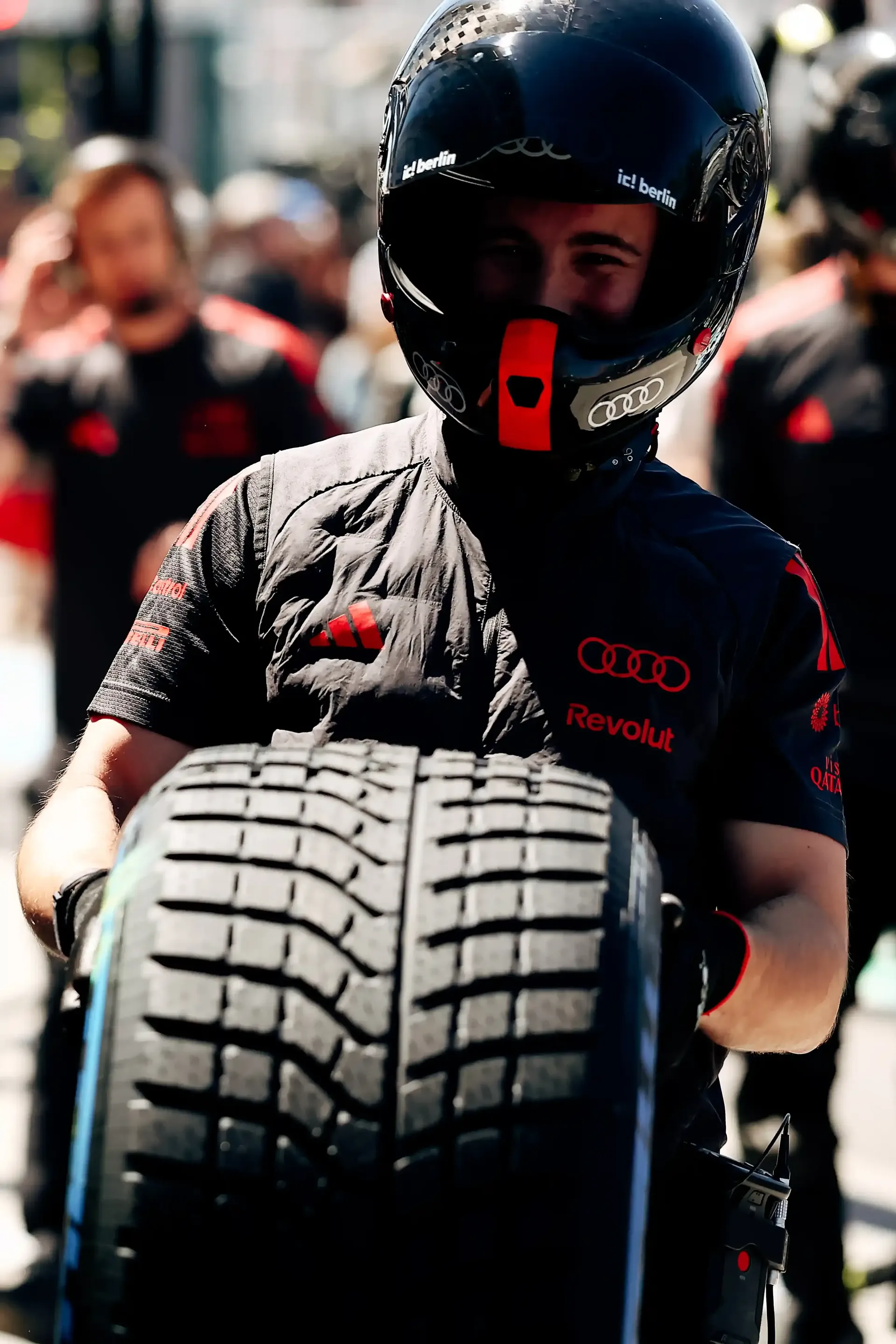 Close up of a Audi Revolut F1® Team crew machanic holding a tire at the pit stop of the Canada Grand Prix 2026