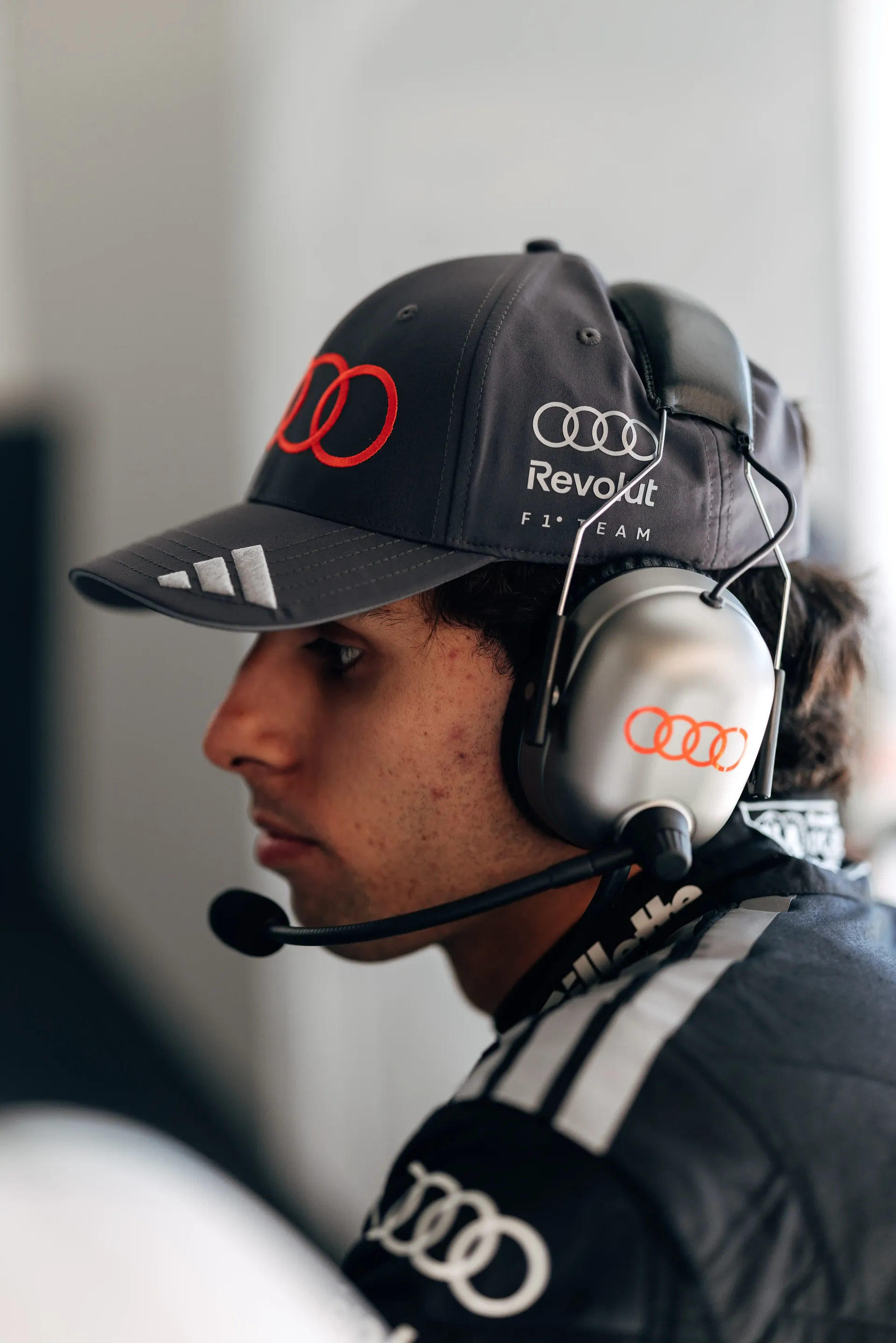 Gabriel Bortoleto inside the Audi Revolut F1® Team garage wearing headphones at the Canada Grand Prix 2026