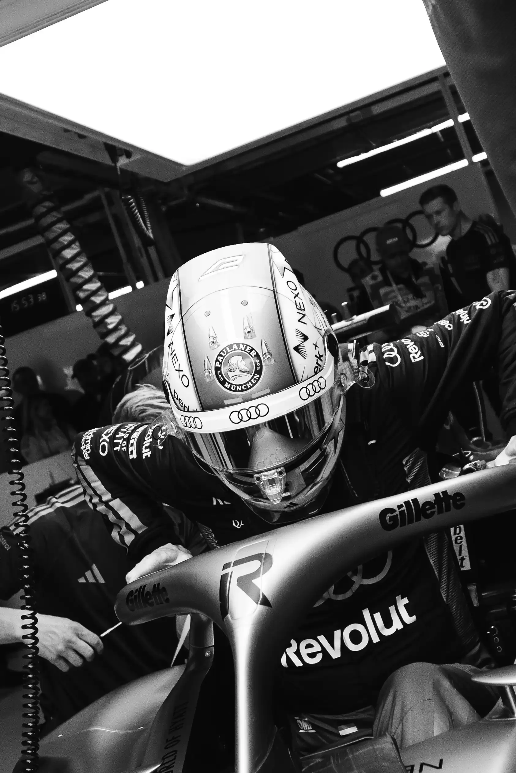 Black and white shot of Nico Hulkenberg driver at the Audi Revolut F1® Team jumps out the cockpit of the R26 car inside the garage at the Canada Grand Prix 2026