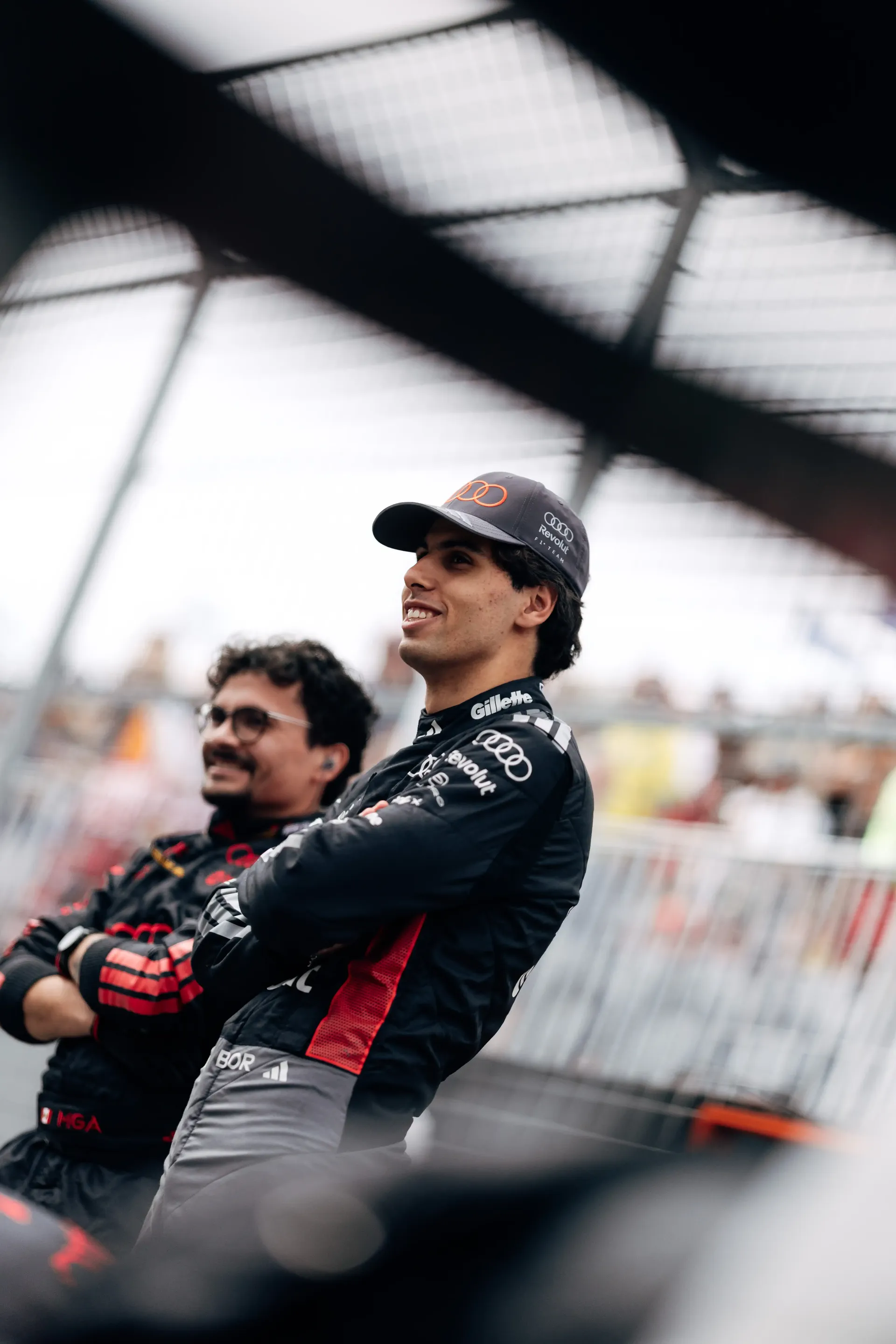 Gabriel Bortoleto driver of the Audi Revolut F1® Team standing with crew member at the side lane of the Canada Grand Prix 2026