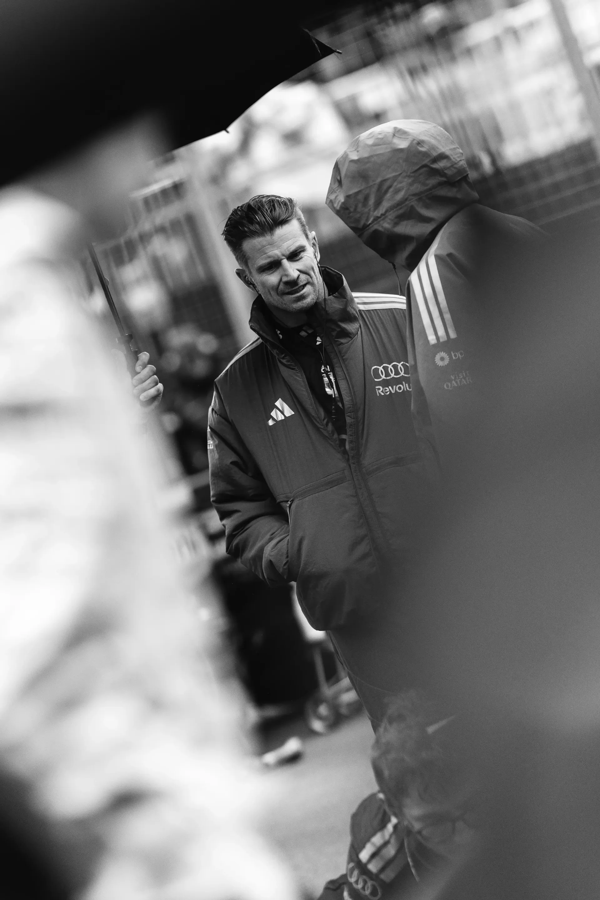 Black and White Close up of Nico Hulkenberg driver at the Audi Revolut F1® Team talking to crew engineer on track at the Canada Grand Prix 2026