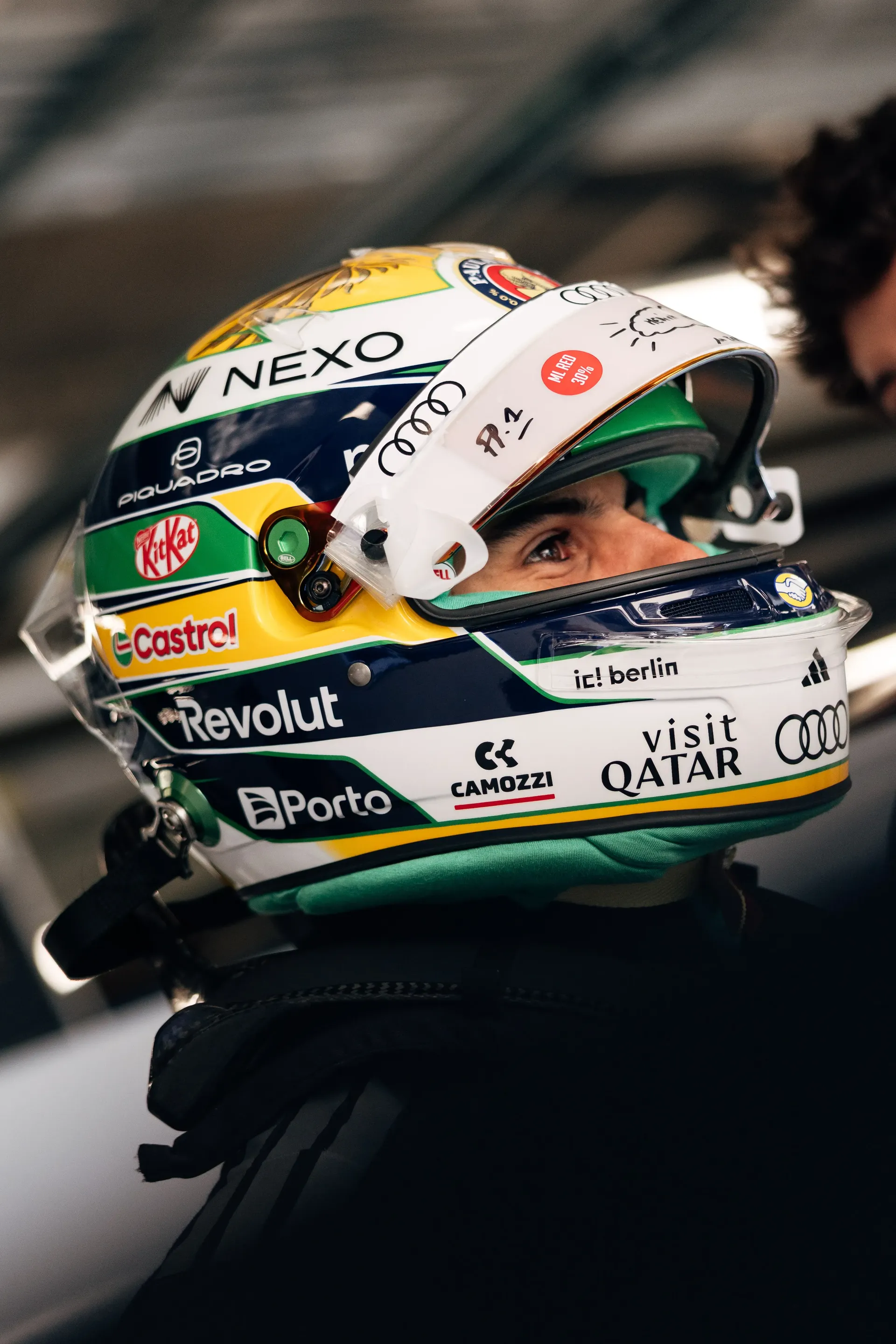 Close-up of Gabriel Bortoleto’s helmet with Brazilian flag colors and sponsor logos.