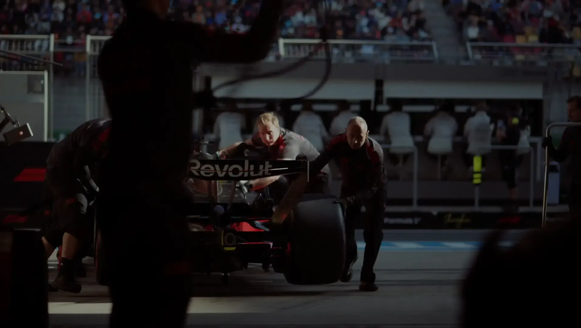 Team members of the Audi Revolut F1® Team inside the garage pulling in the car