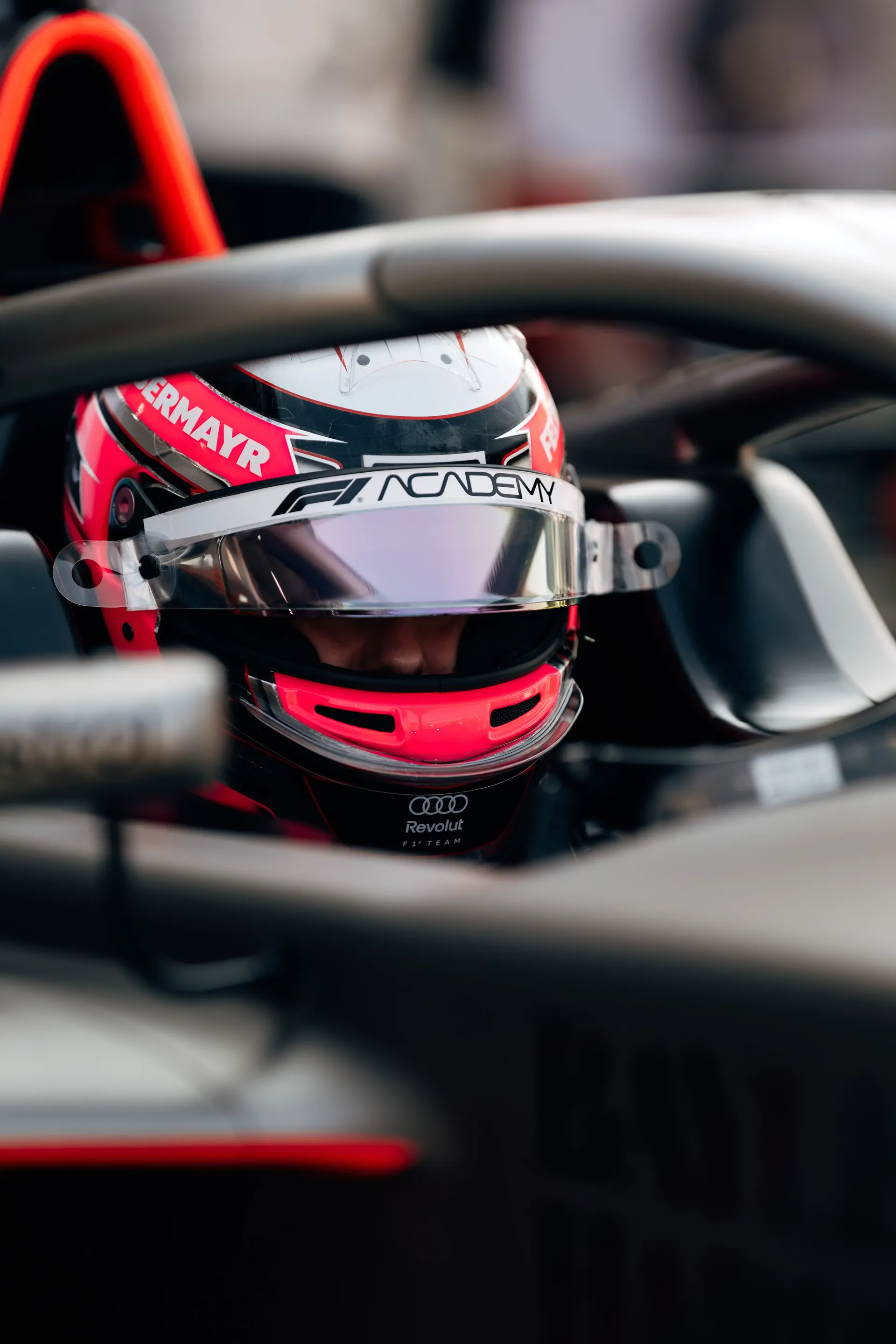 Close-up of Emma Felbermayr, Audi Revolut F1® Team Academy driver, helmet and halo inside the Formula 1 cockpit.