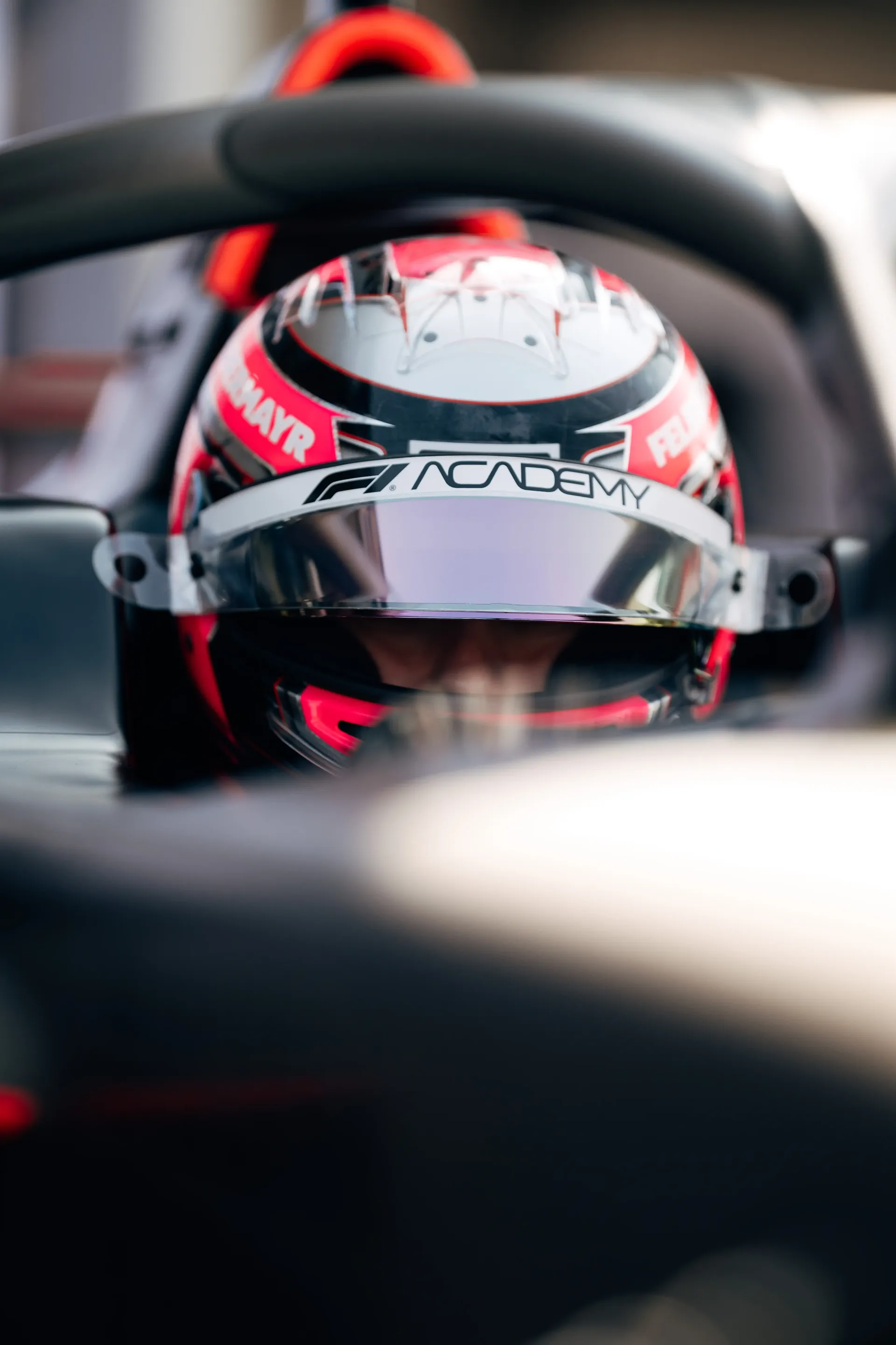 Emma Felbermayr, Audi Revolut F1® Team Academy driver, seen through the cockpit opening of the Formula 1 car.