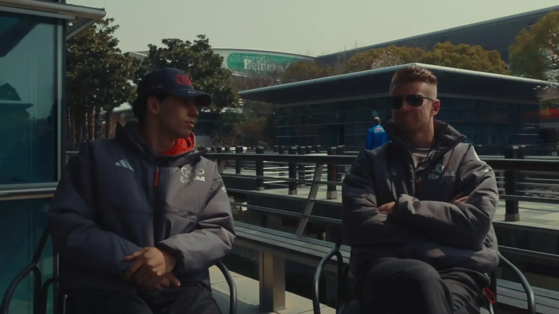 Gabriel Bortoleto and Nico Hulkenberg debating essential life questions in front of the Chinese Gran Prix racetrack in Shanghai