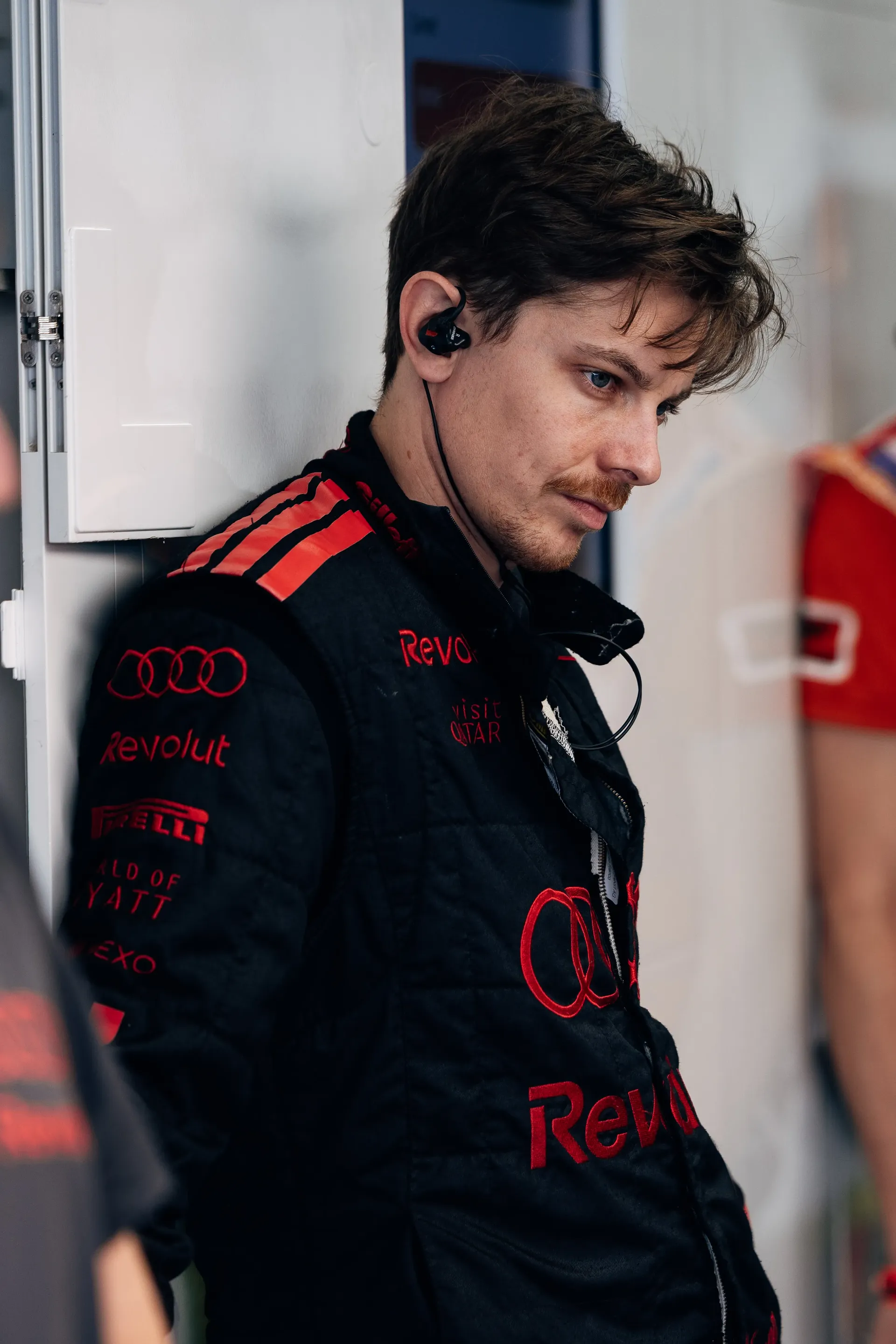 Audi Revolut F1® Team mechanic in team racewear inside the paddock.