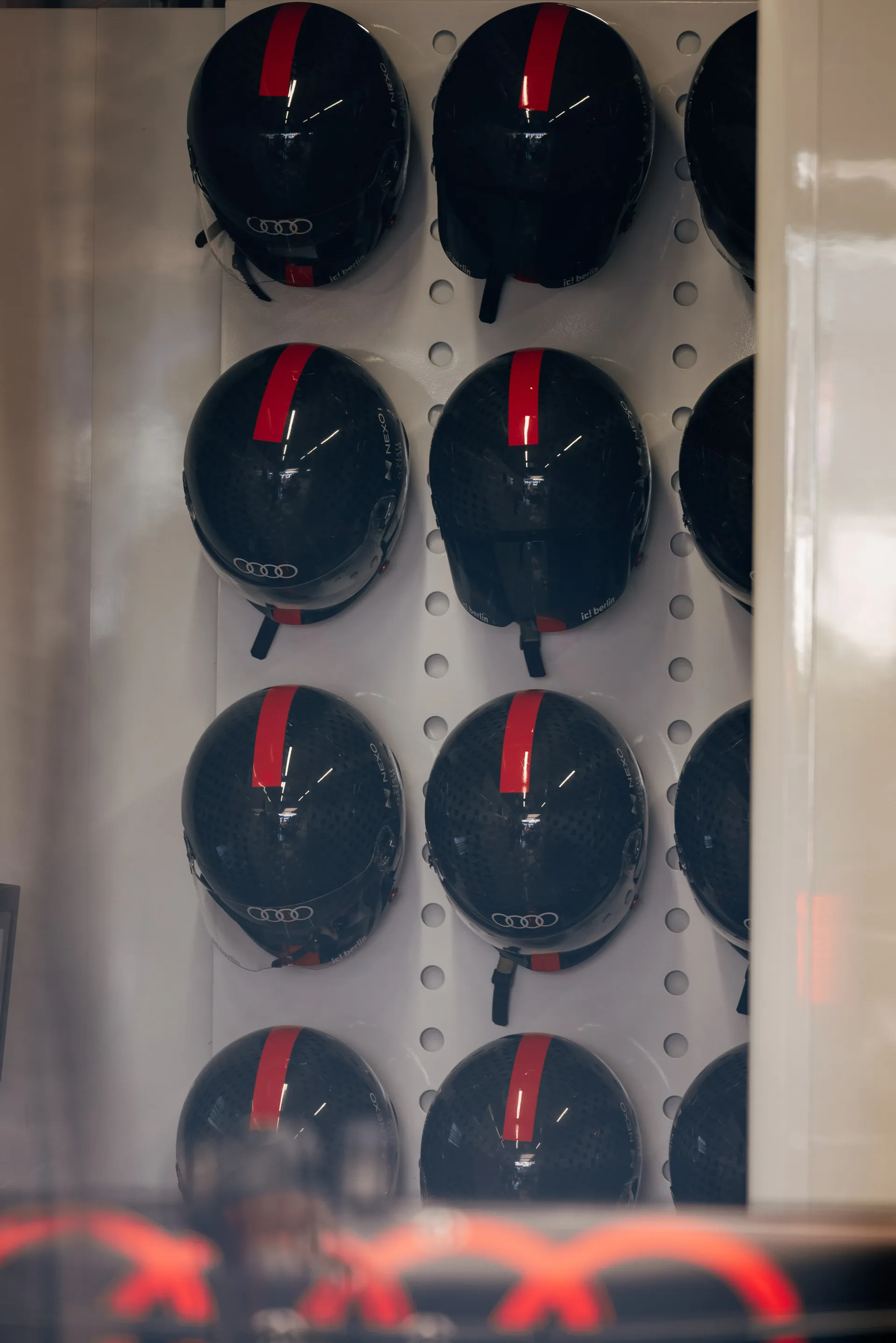 Audi Revolut F1® Team helmets displayed in the garage.