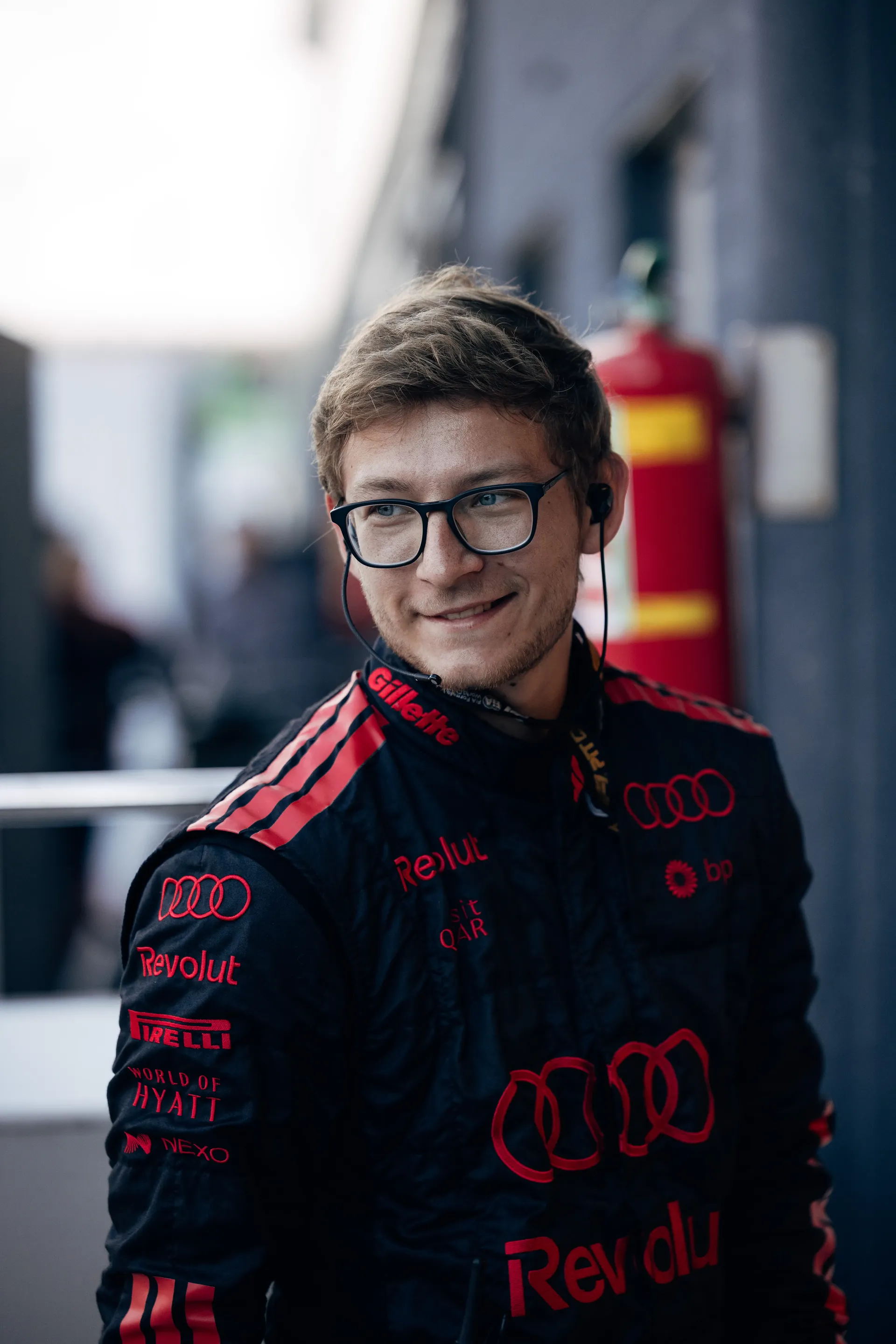Audi Revolut F1® Team mechanic smiling inside the paddock.