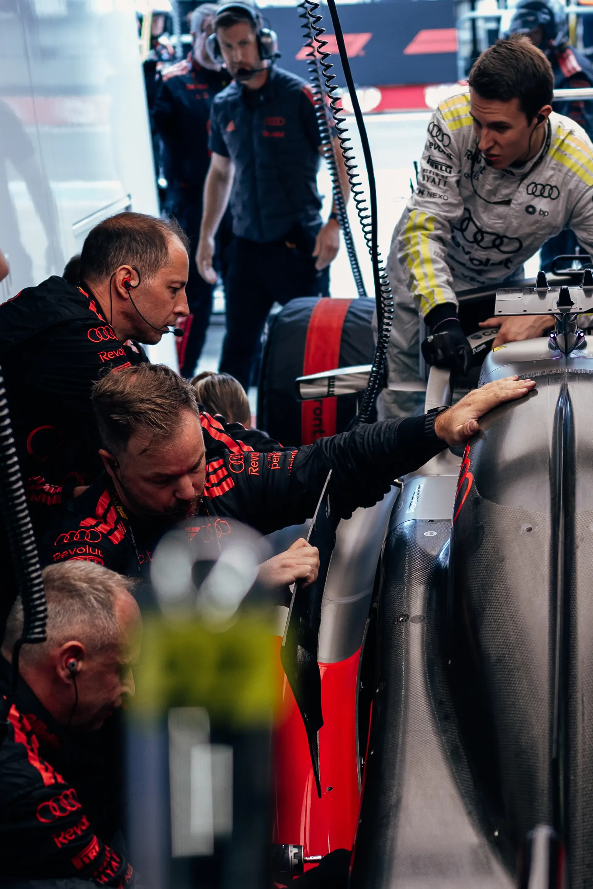 Audi Revolut F1® Team mechanics working on the car during preparations.