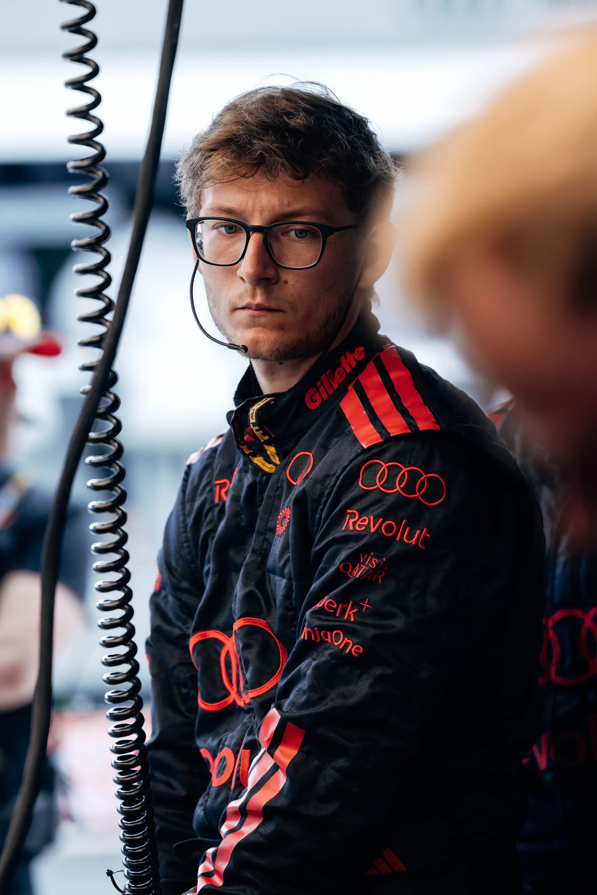 Audi Revolut F1® Team mechanic standing inside the garage.