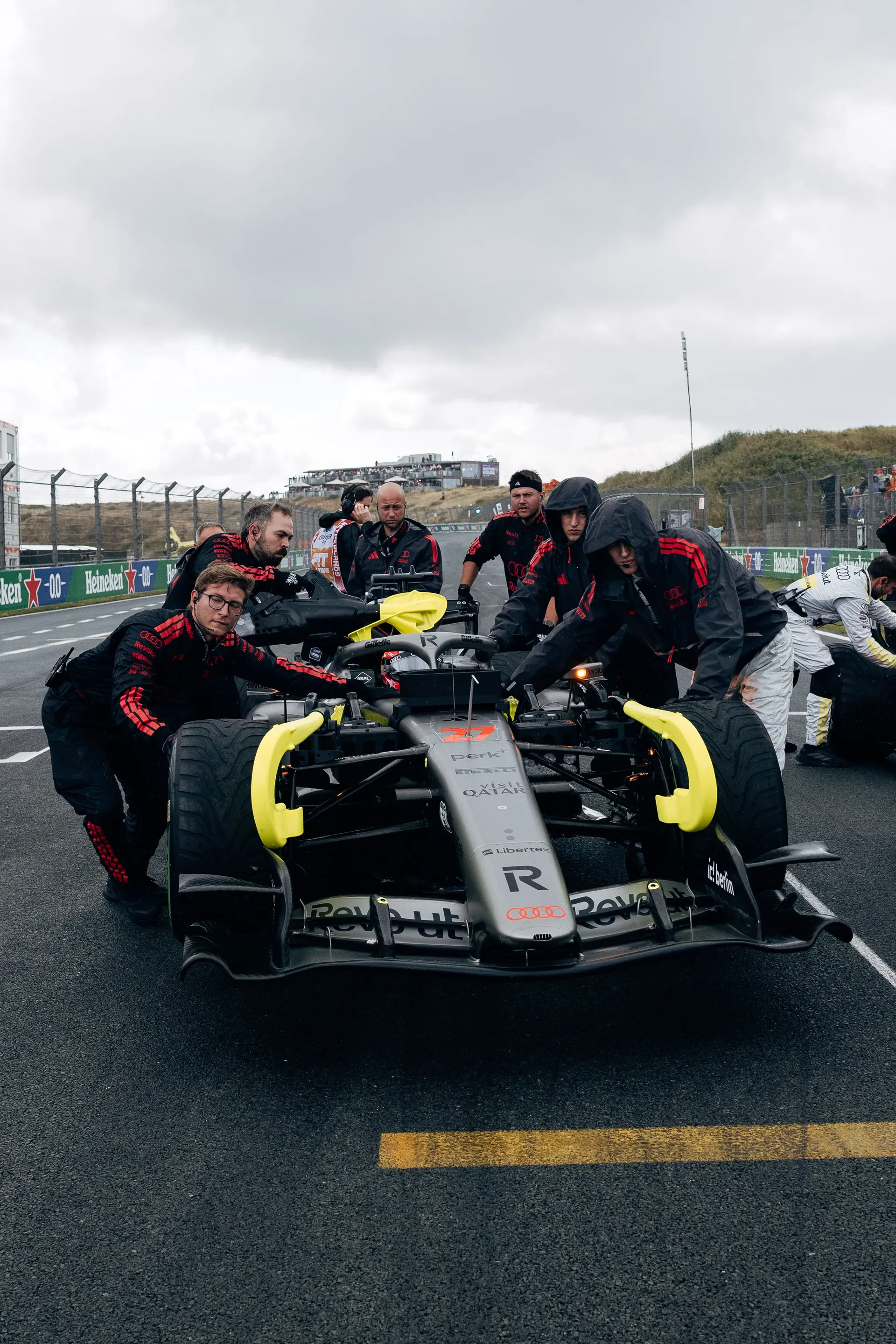 Audi Revolut F1® Team mechanics push the Audi R26 into position on the Dutch Grand Prix grid.