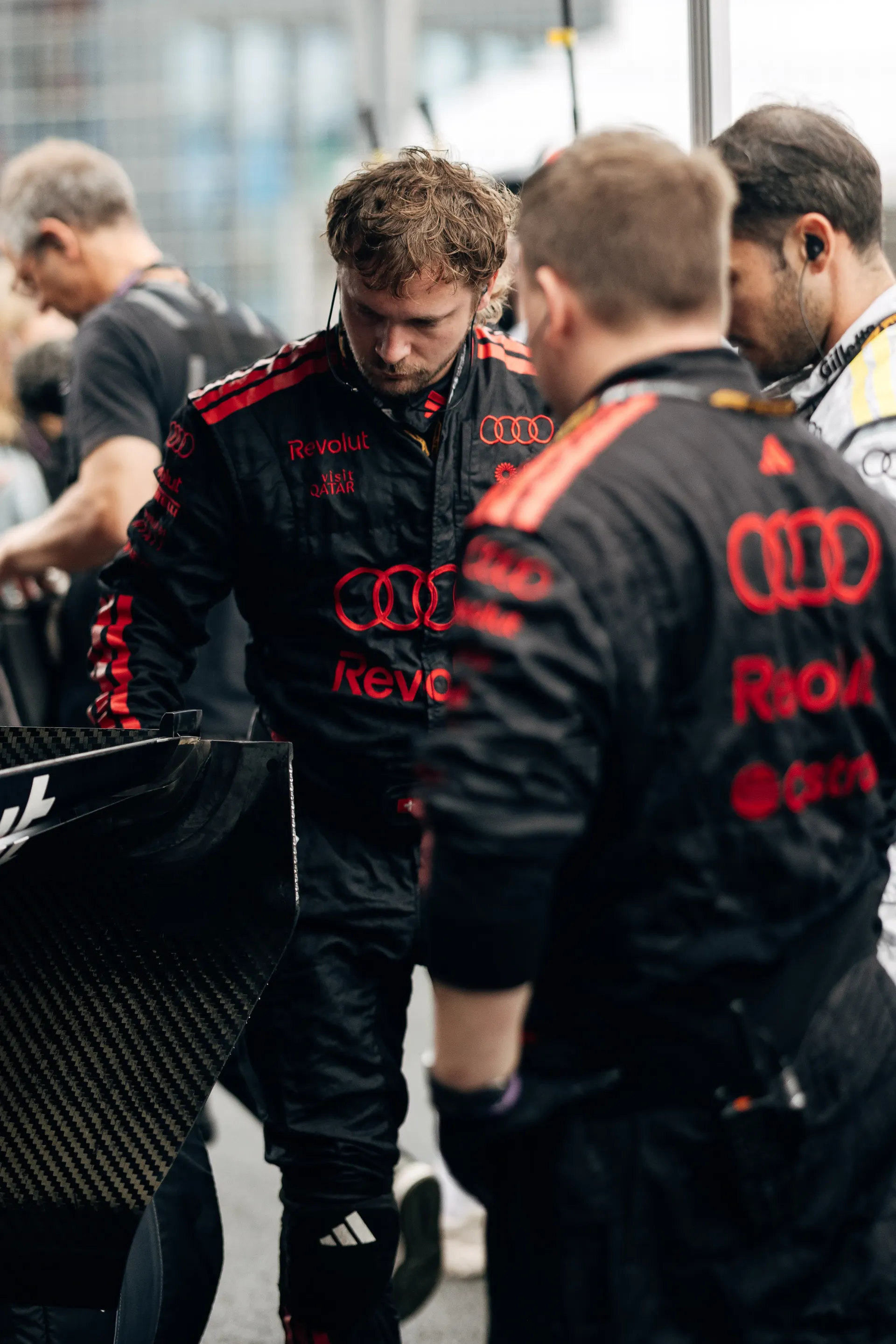Audi Revolut F1® Team mechanics gather around the Audi R26 ahead of the race.
