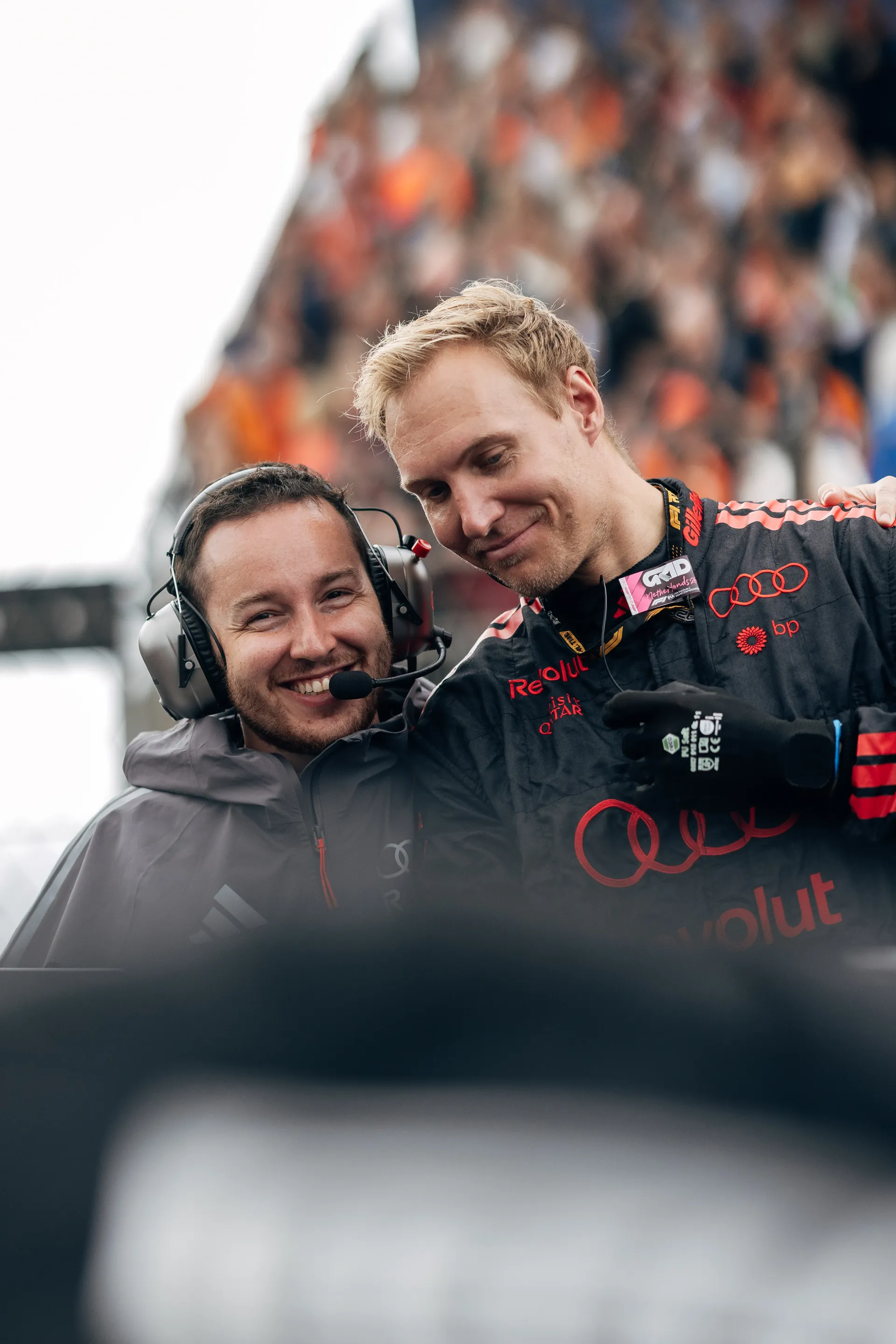 Two Audi Revolut F1® Team mechanics smile together on the Dutch Grand Prix grid.