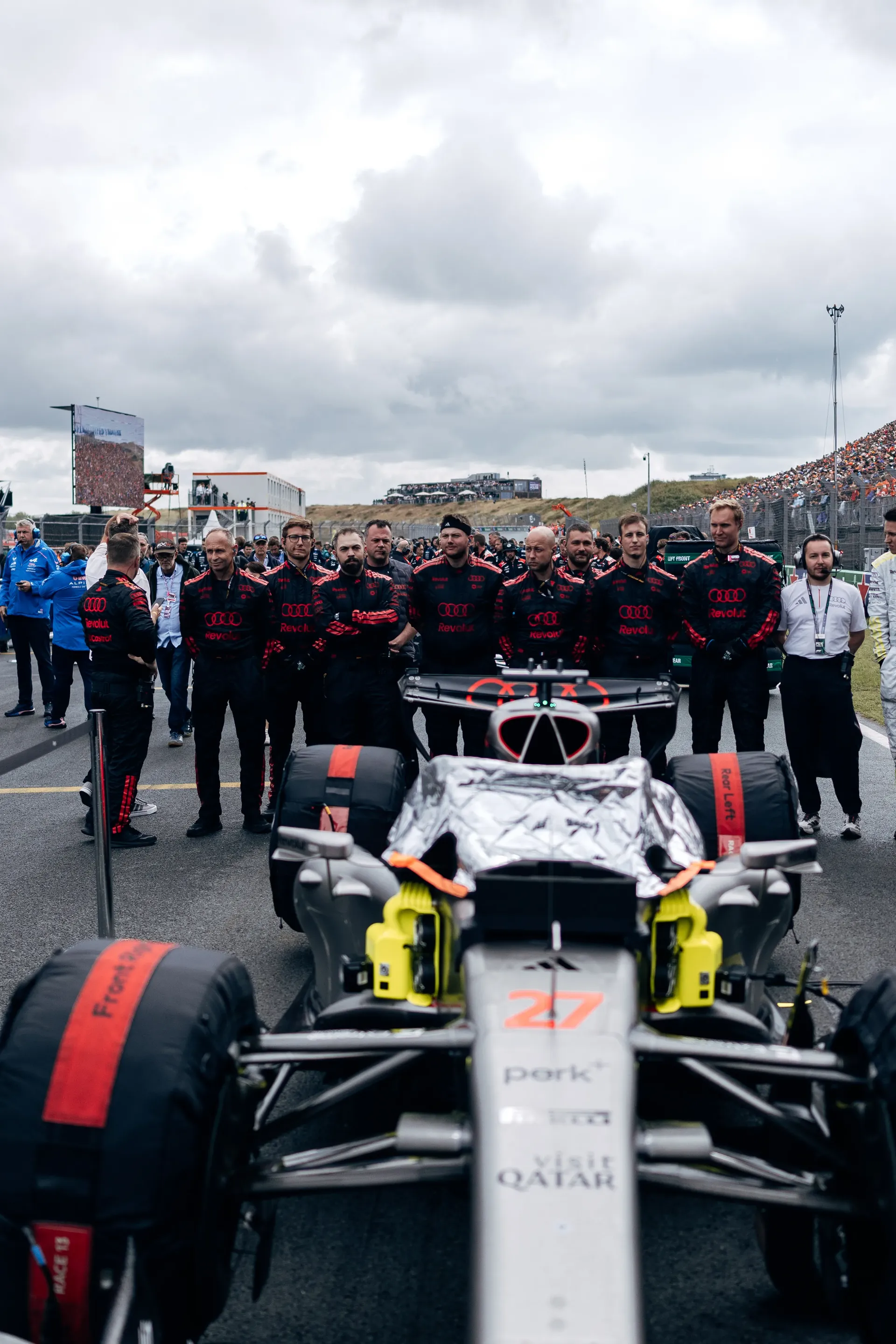 Audi R26 sits on the grid surrounded by Audi Revolut F1® Team mechanics ahead of the Dutch Grand Prix.