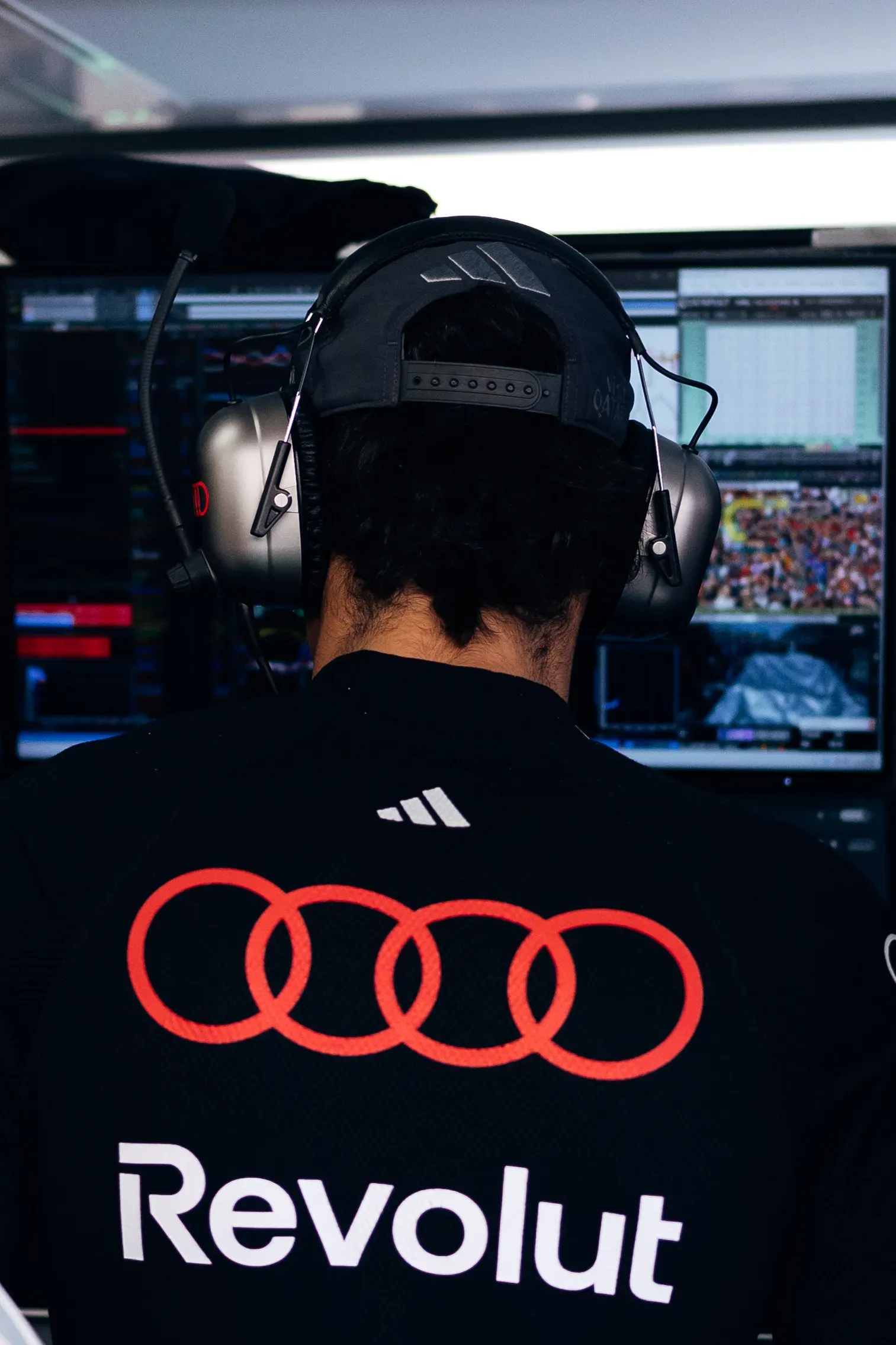 Audi Revolut F1® Team driver Gabriel Bortoleto monitors live race information from the garage.