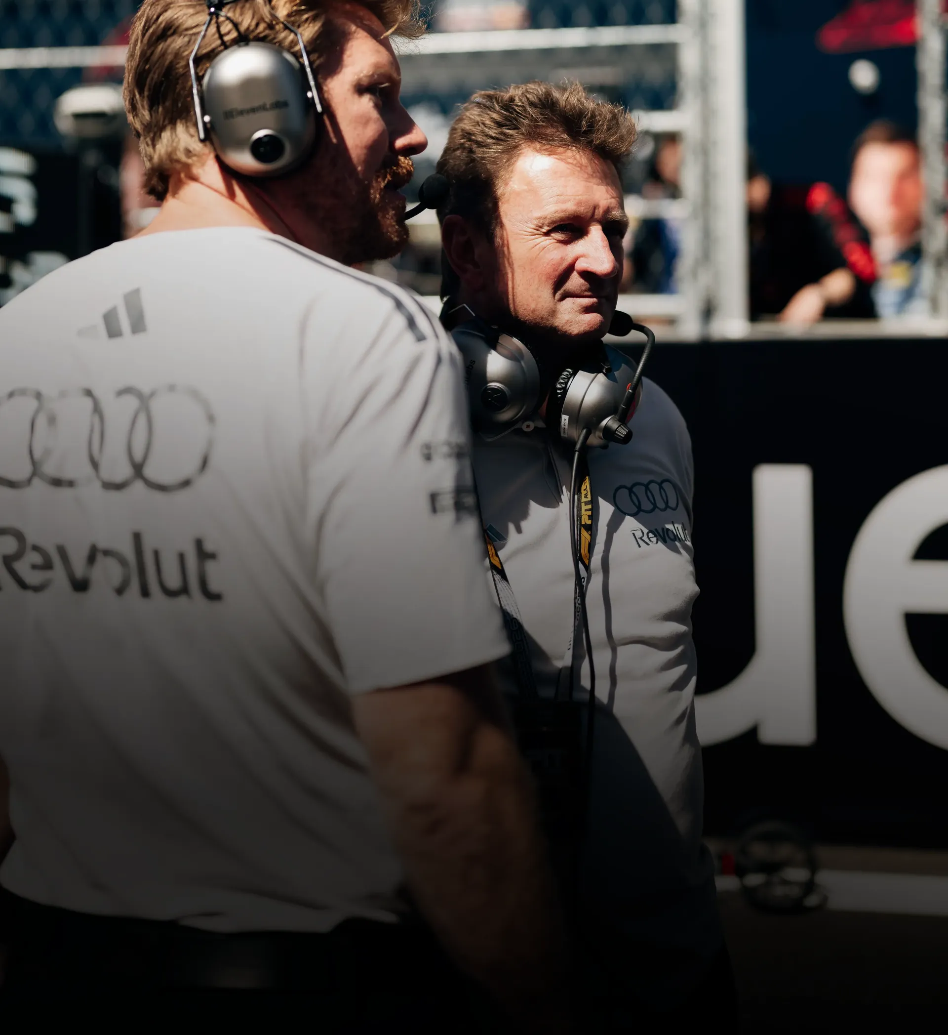 Audi Revolut F1® Team racing director Allan McNish in conversation with team engineer waring headsets on the grid at the Spanish Grand prix 2026 in Madrid