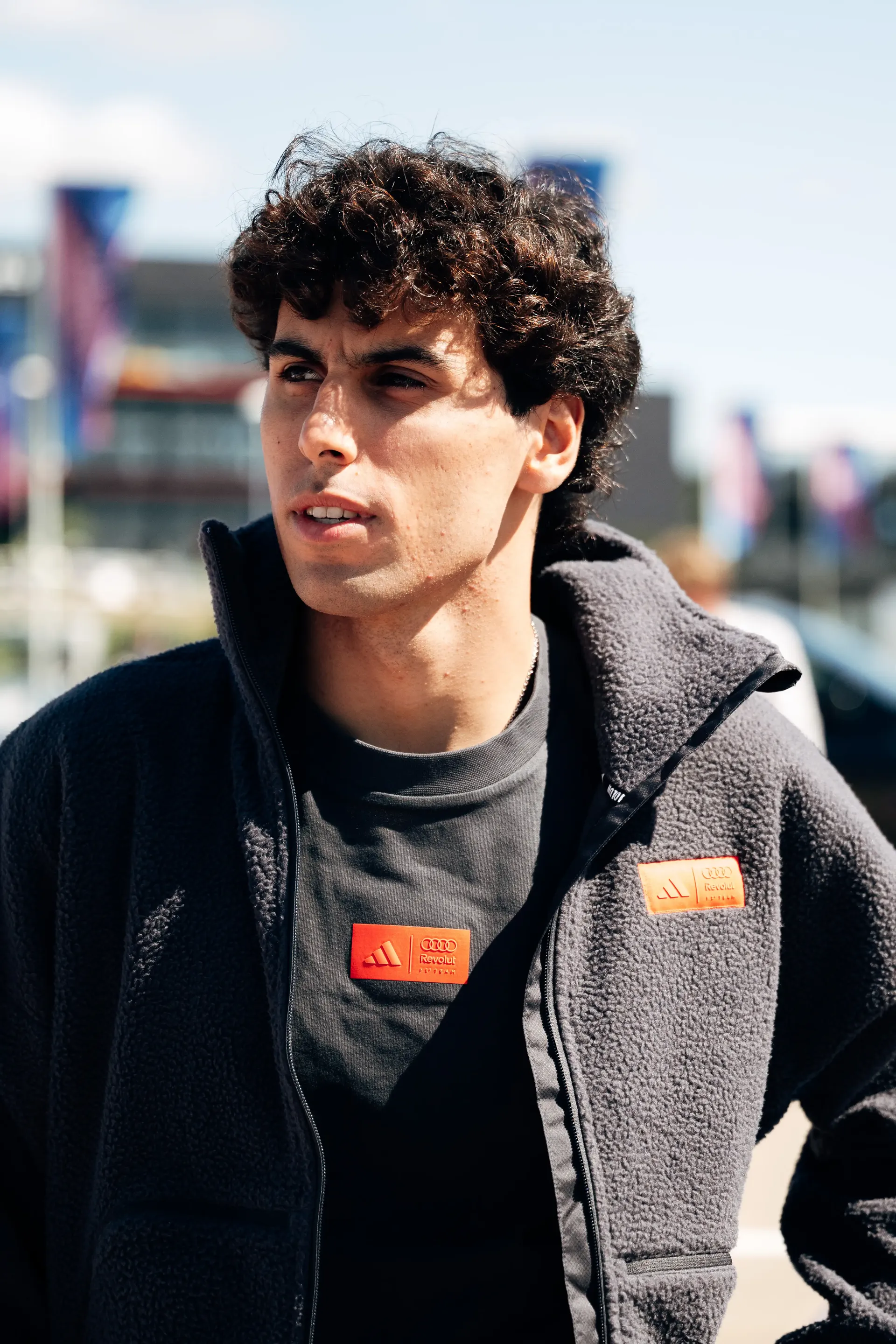 Gabriel Bortoleto, driver at the Audi Revolut F1® Team, arrives at the British Grand Prix wearing the adidas Elevated Fanwear Collection.