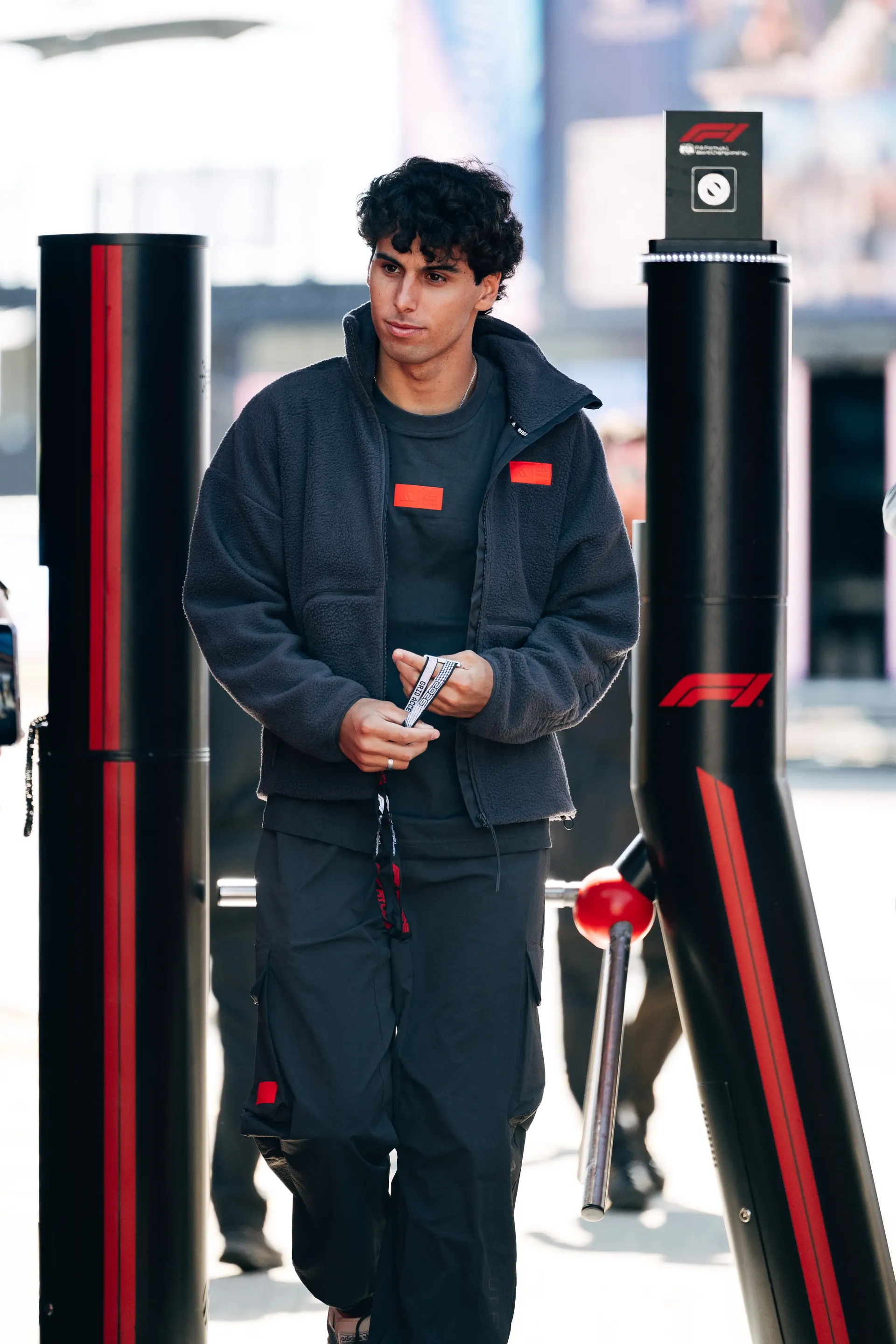Gabriel Bortoleto, driver at the Audi Revolut F1® Team, arrives at the British Grand Prix paddock wearing the adidas Elevated Fanwear Collection.