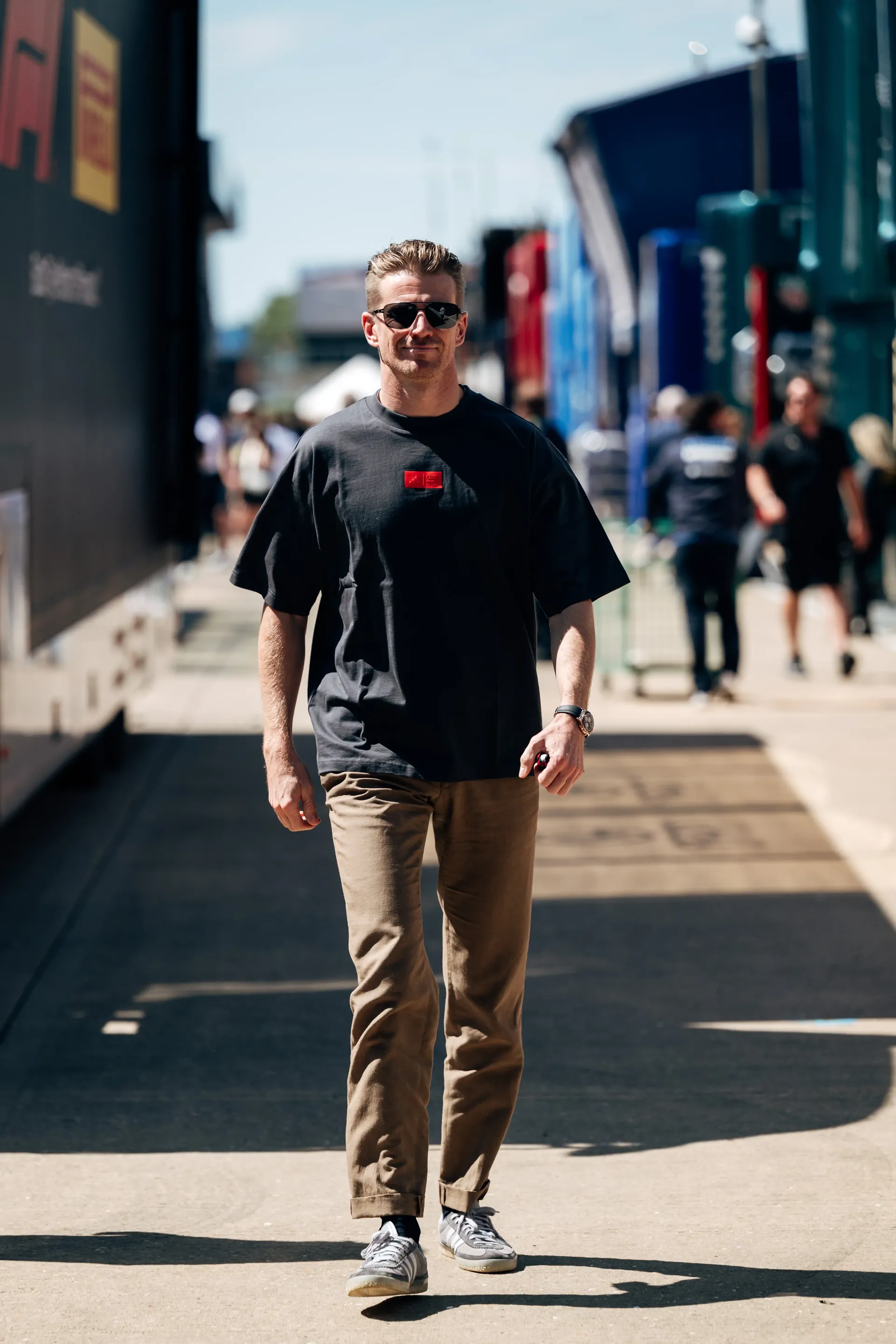 Nico Hulkenberg, driver at the Audi Revolut F1® Team, walks through the paddock after arriving at the British Grand Prix wearing the adidas Elevated Fanwear Collection.