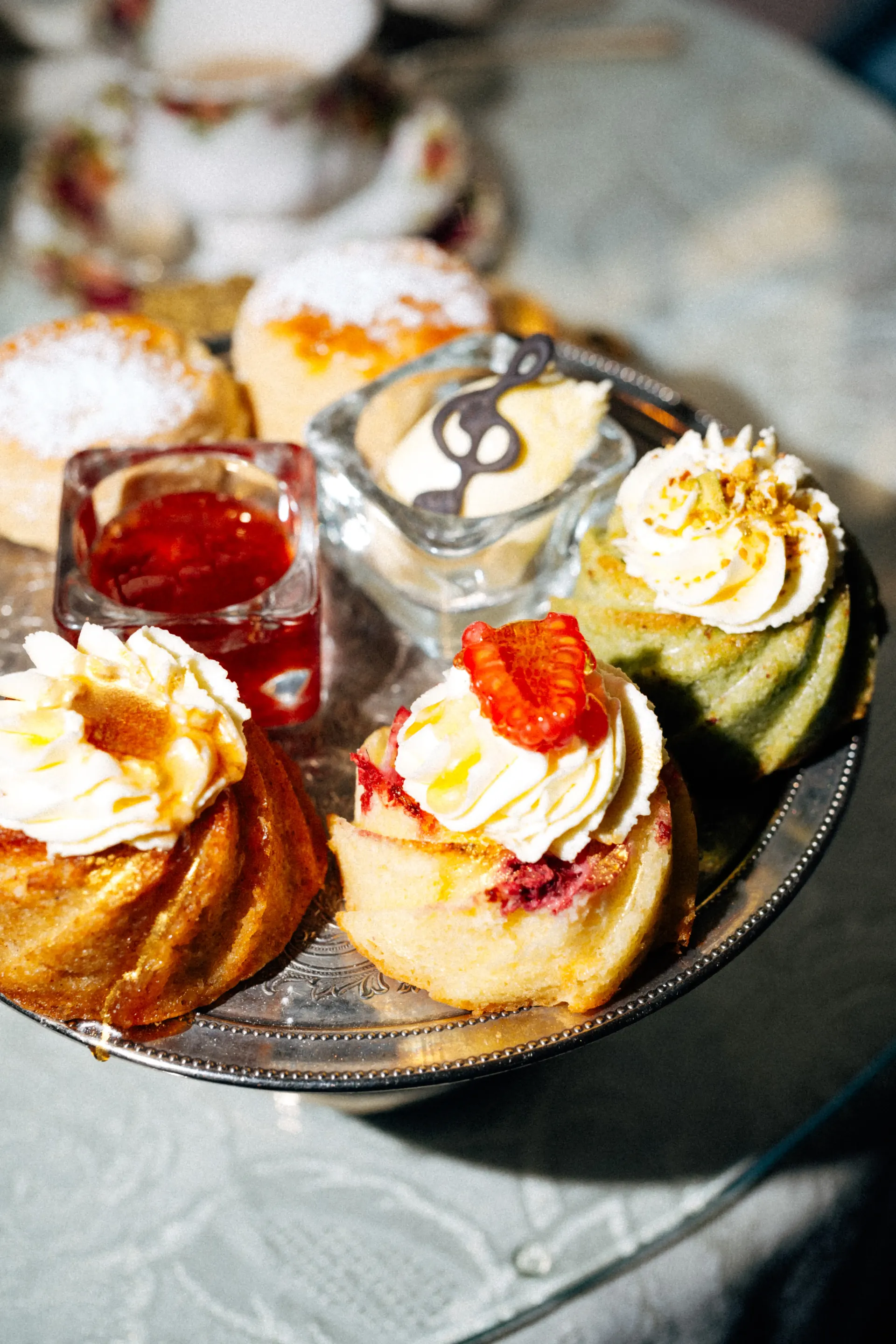 Assorted cakes and pastries served on a tiered afternoon tea stand.