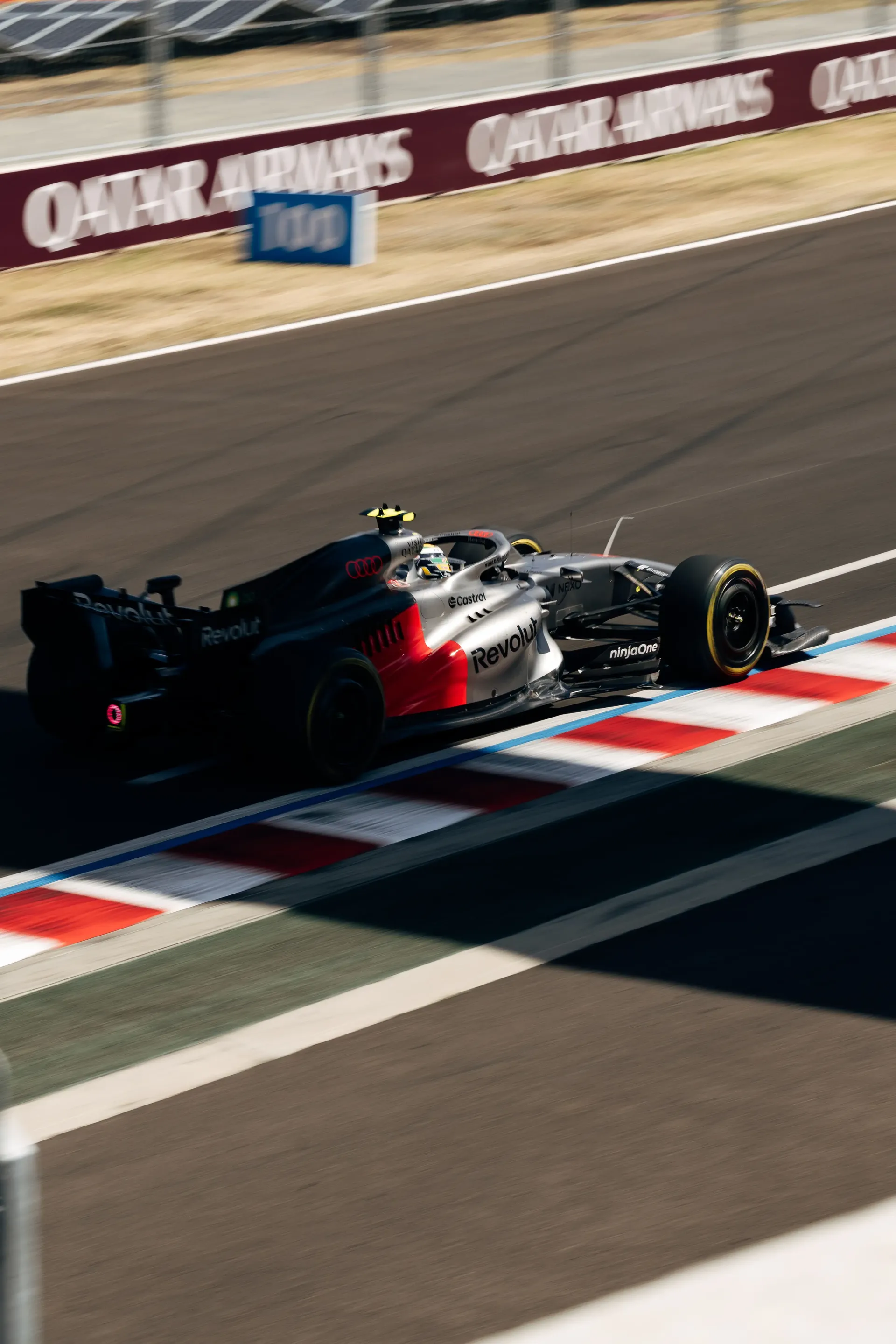 The Audi Revolut F1® Team Audi R26 rides the kerbs during FP3 at the Hungaroring.